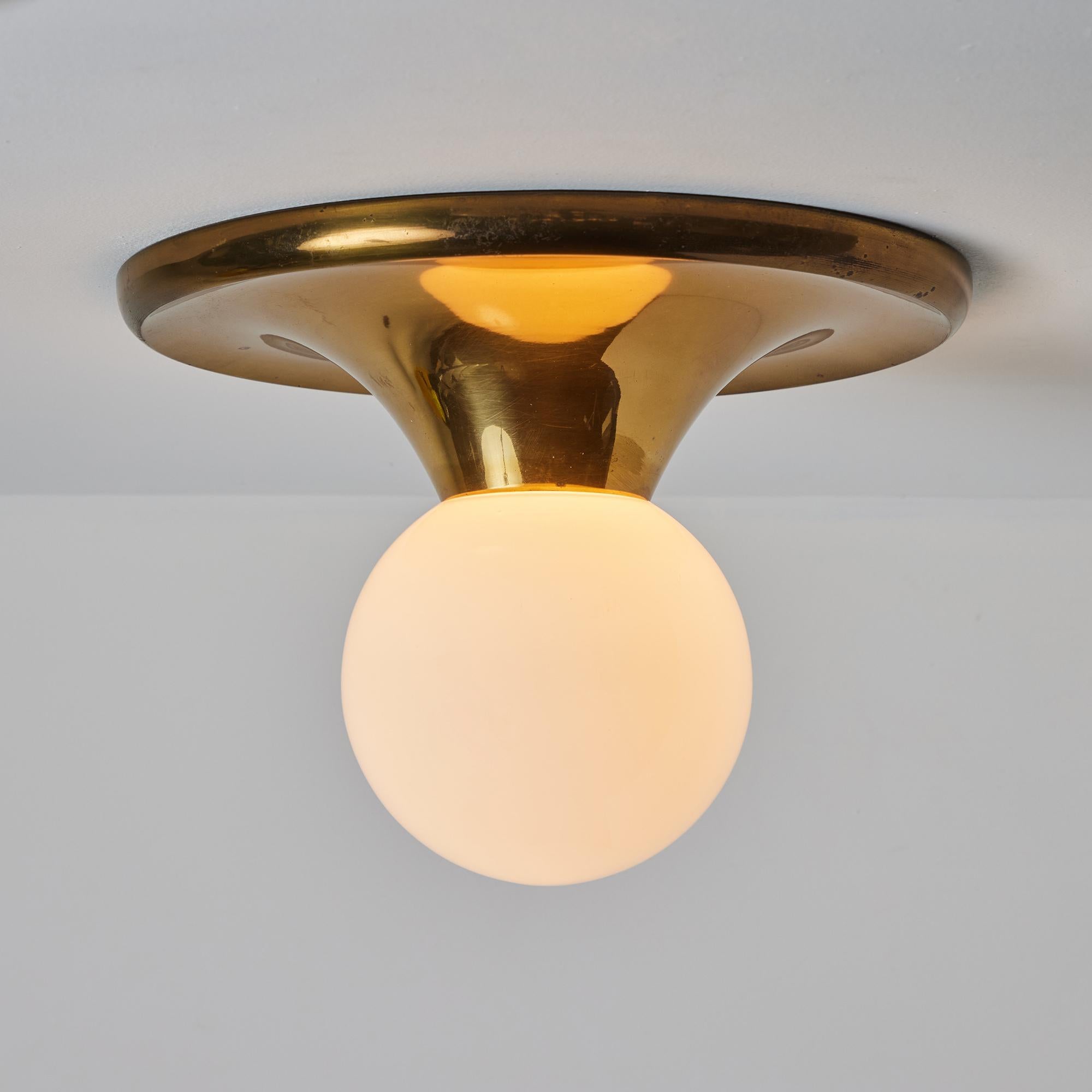 Large 1960s Achille Castiglioni & Pier Giacomo 'Light Ball' Wall or Ceiling Lamp. Designed in 1965, this rare variant is executed in attractively patinated brass and opaline glass. An incredibly refined and iconic midcentury design that is