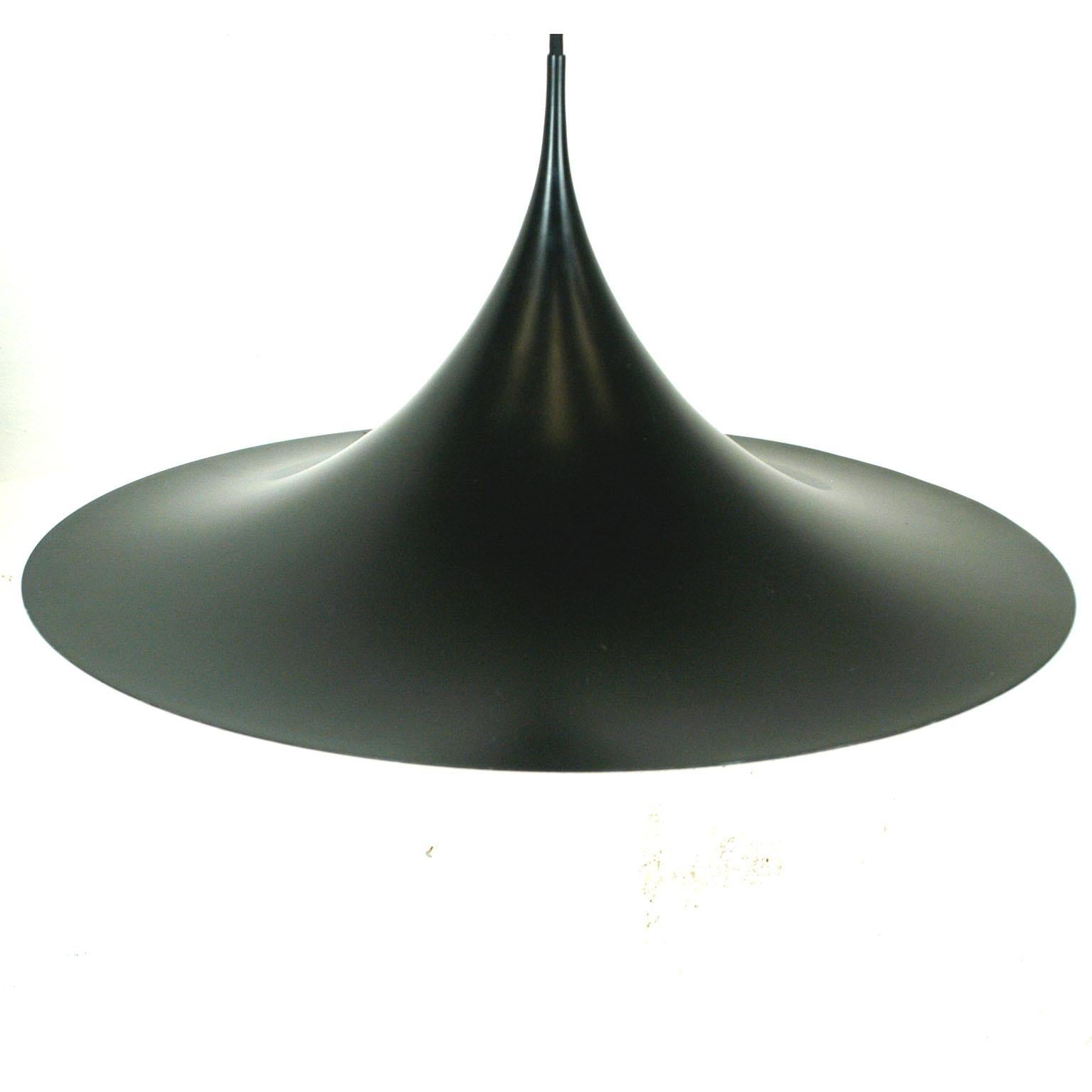 Large black lacquered with offwhite interior Semi pendant lamp. The Semi is one of the most iconic designs by Fog and Mørup. It is in very good condition with a few smaller signs af wear and has a 60 cm diameter, making it perfect over a large