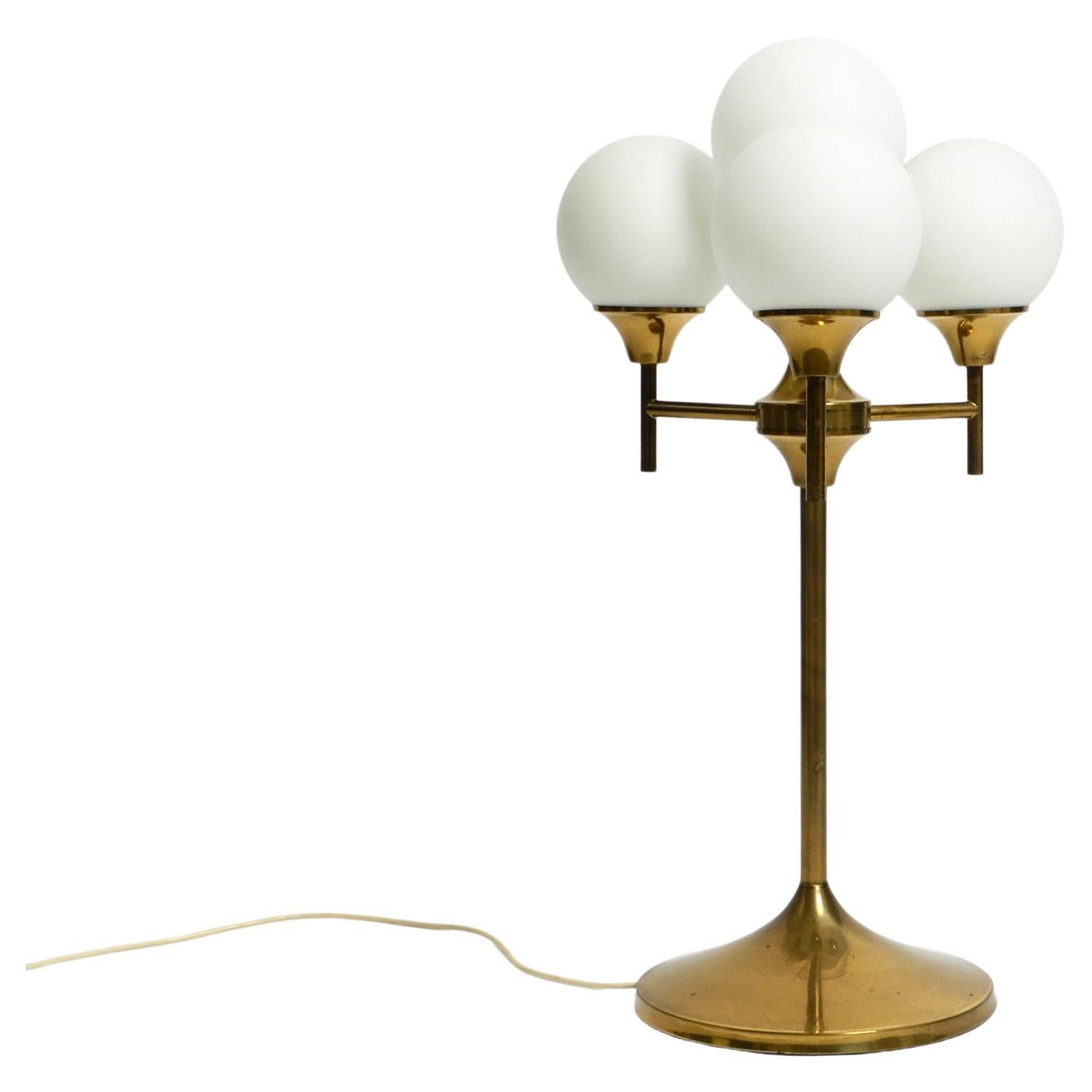 Large 1960s brass table or floor lamp with 4 glass spheres by Kaiser Leuchten For Sale