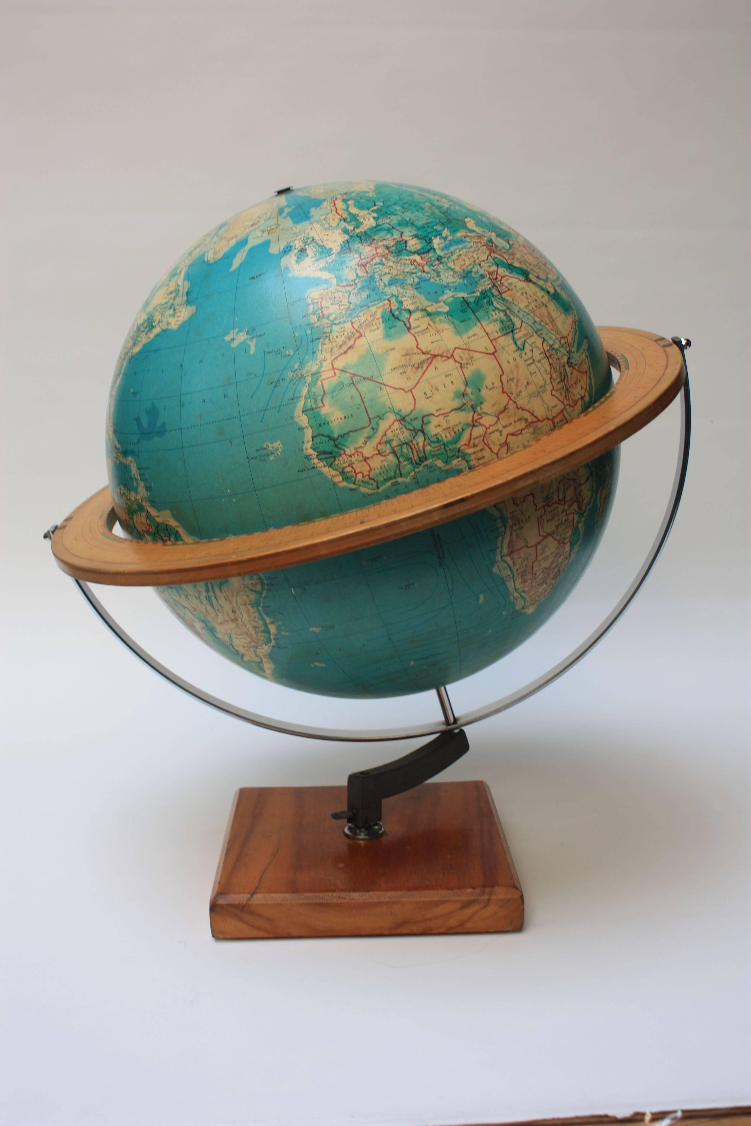 Denoyer-Geppert Co. of Chicago, IL 'Cartocraft 16 inch Visual Relief Globe' composed of paper gores over plastic, featuring the basic details of a student demonstration globe: International Date Line, Ecliptic and analemma. Adjustable, wood horizon