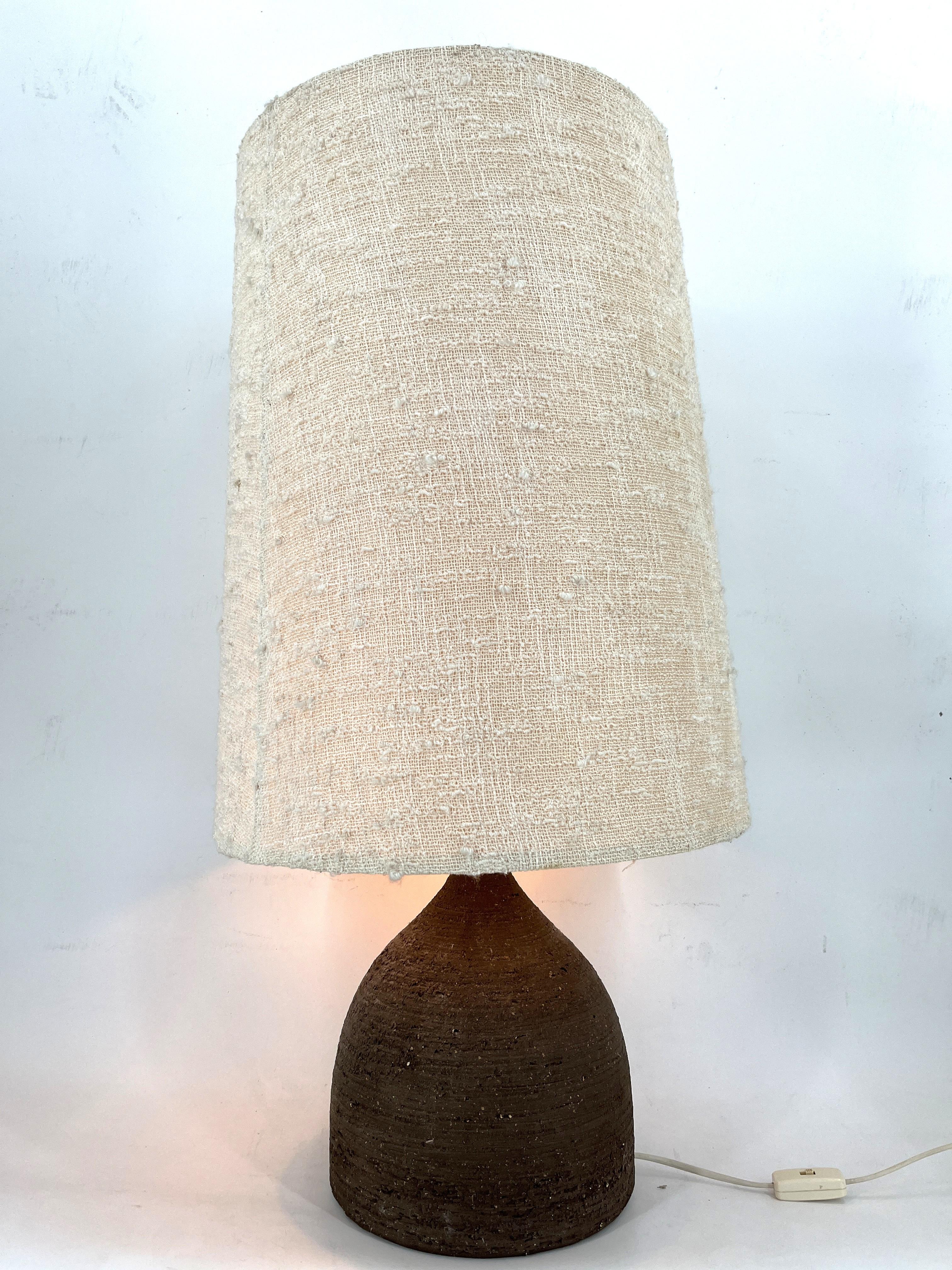 Large decorative table or floor lamp by Pottery Manufacturer Krösselbach.

The base is made of rough, unglazed dark brown ceramic manganese fireclay and it come with its original large fabric lamp shade.

The lamp has been tested and works with a