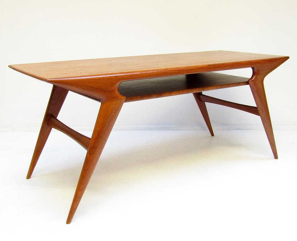 A striking 1960s Danish coffee table in teak by Johannes Andersen.

With contoured form and splayed, tapered legs, it is the most stunning coffee table of the period we have seen.

This large coffee table has an expansive undertier for