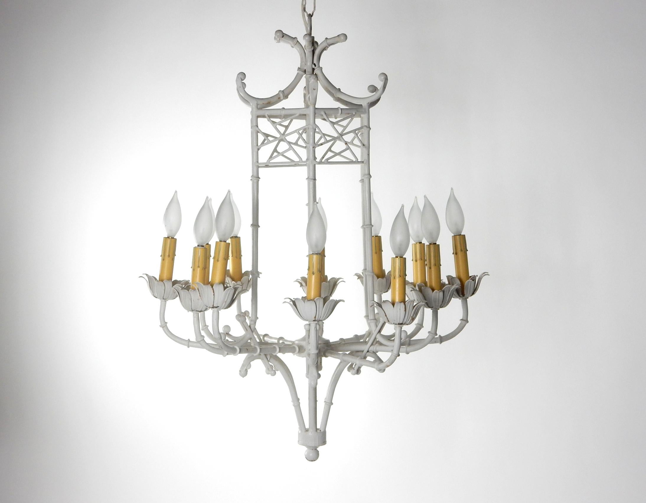 Fabulous 1960s faux bamboo pagoda chandelier.
12 bulbs. Creamy white enamel over metal construction.
Original realistic drip candle sleeves.
Measures: 32