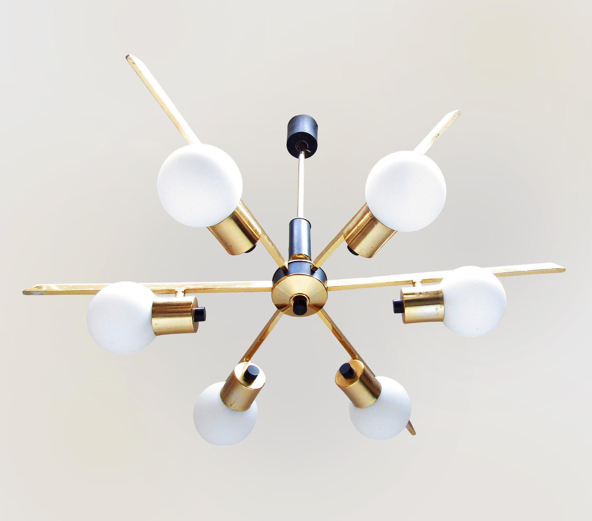 A large, original 1960s six-arm chandelier by French makers Maison Arlus.

The globe shades are made from opaque matt glass. They are held stylish brass holders, mounted on splayed starburst arms.

In good working condition, this chandelier evokes a