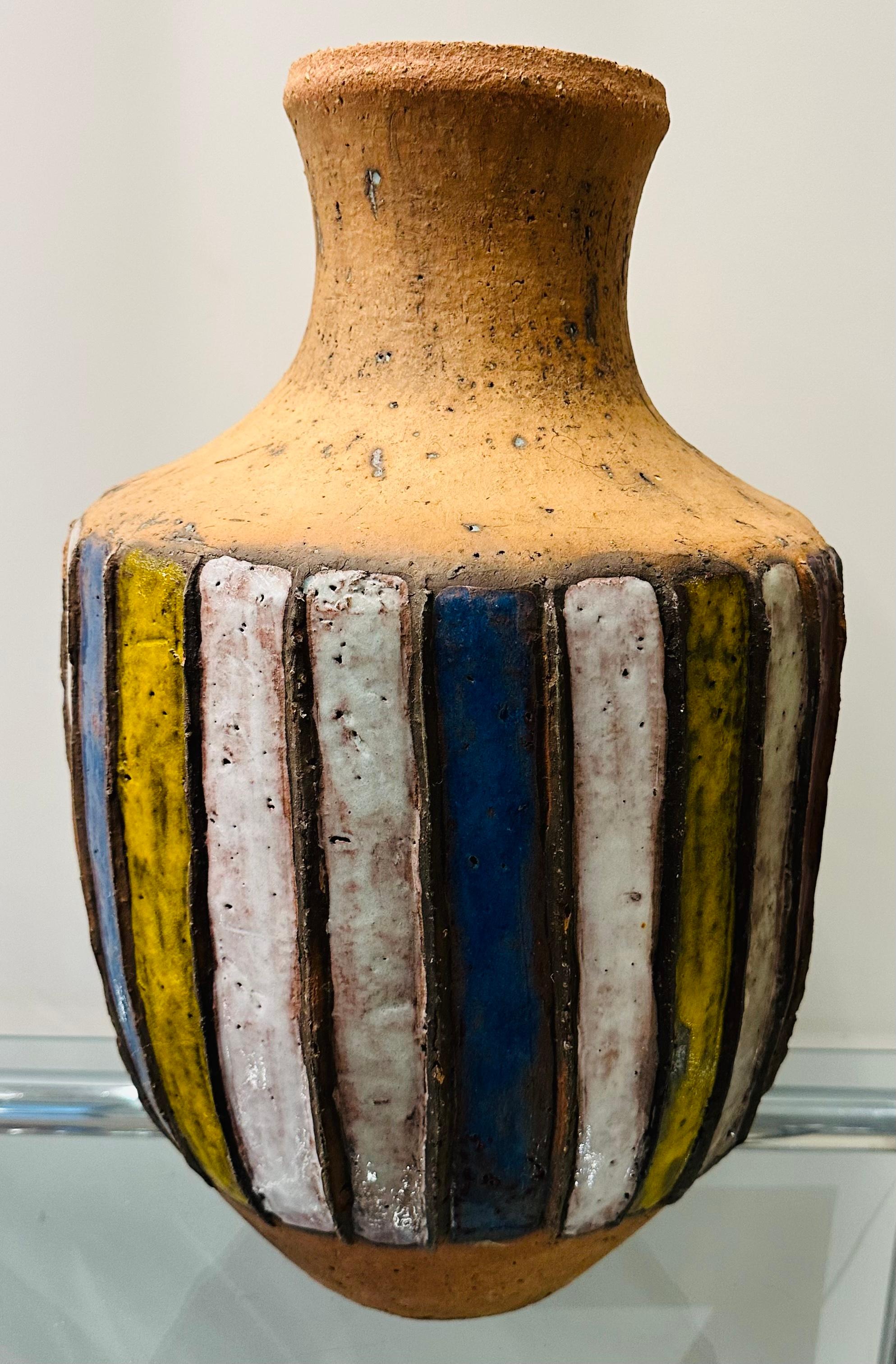 A large 1960s Italian multicoloured glazed and unglazed striped earthenware pottery vase or urn. 
In a very good rustic pre-used condition.  There is a tiny chip on one of the raised borders between the yellow and white glazed stripes which is