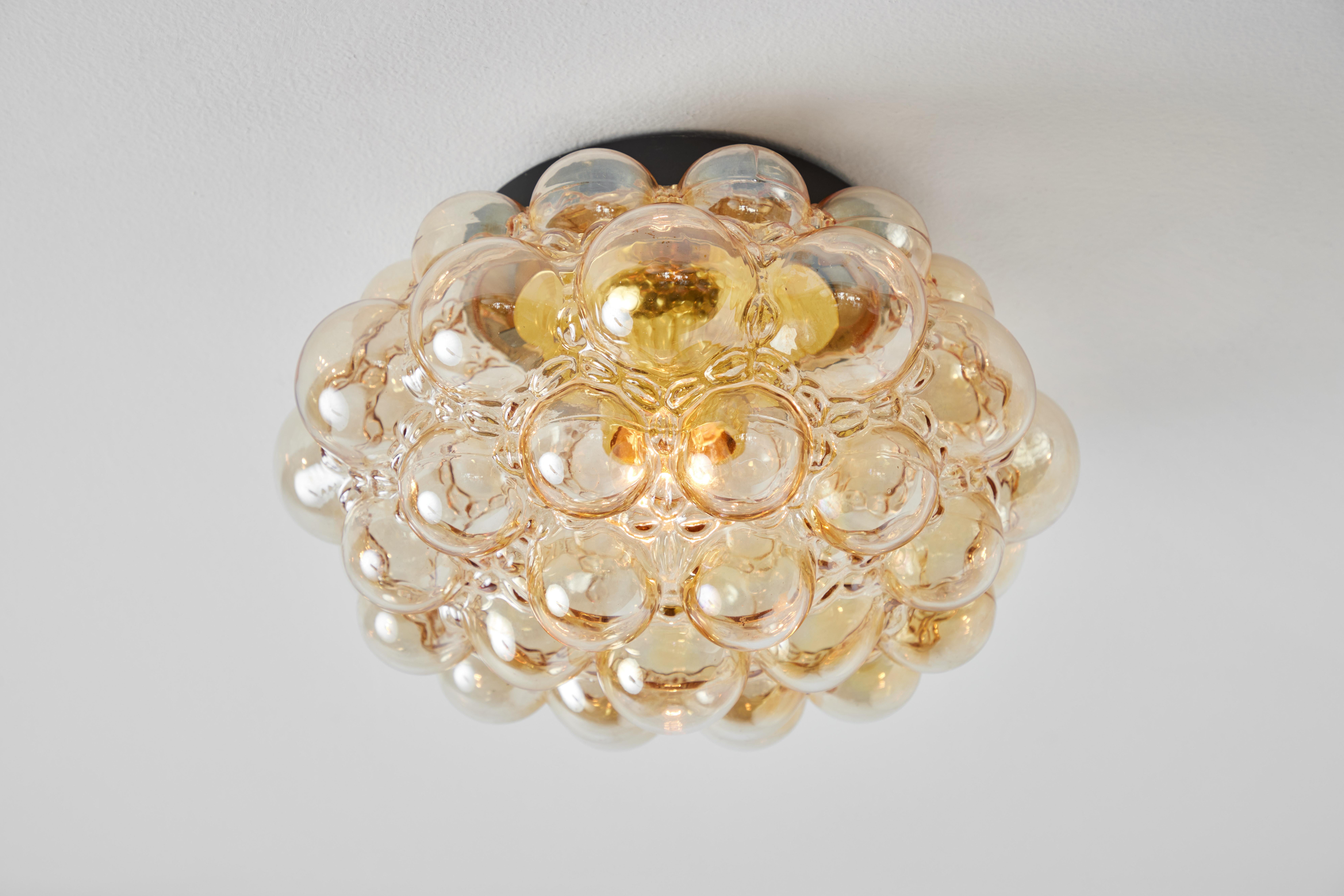 Large 1960s Helena Tynell model # A204 / 2045 amber bubble glass lamp for Limburg. Executed in thick and heavy textured amber bubble glass and painted metal mount. Can be mounted on the ceiling or used as a wall lamp. Fabricated in Limburg, Germany