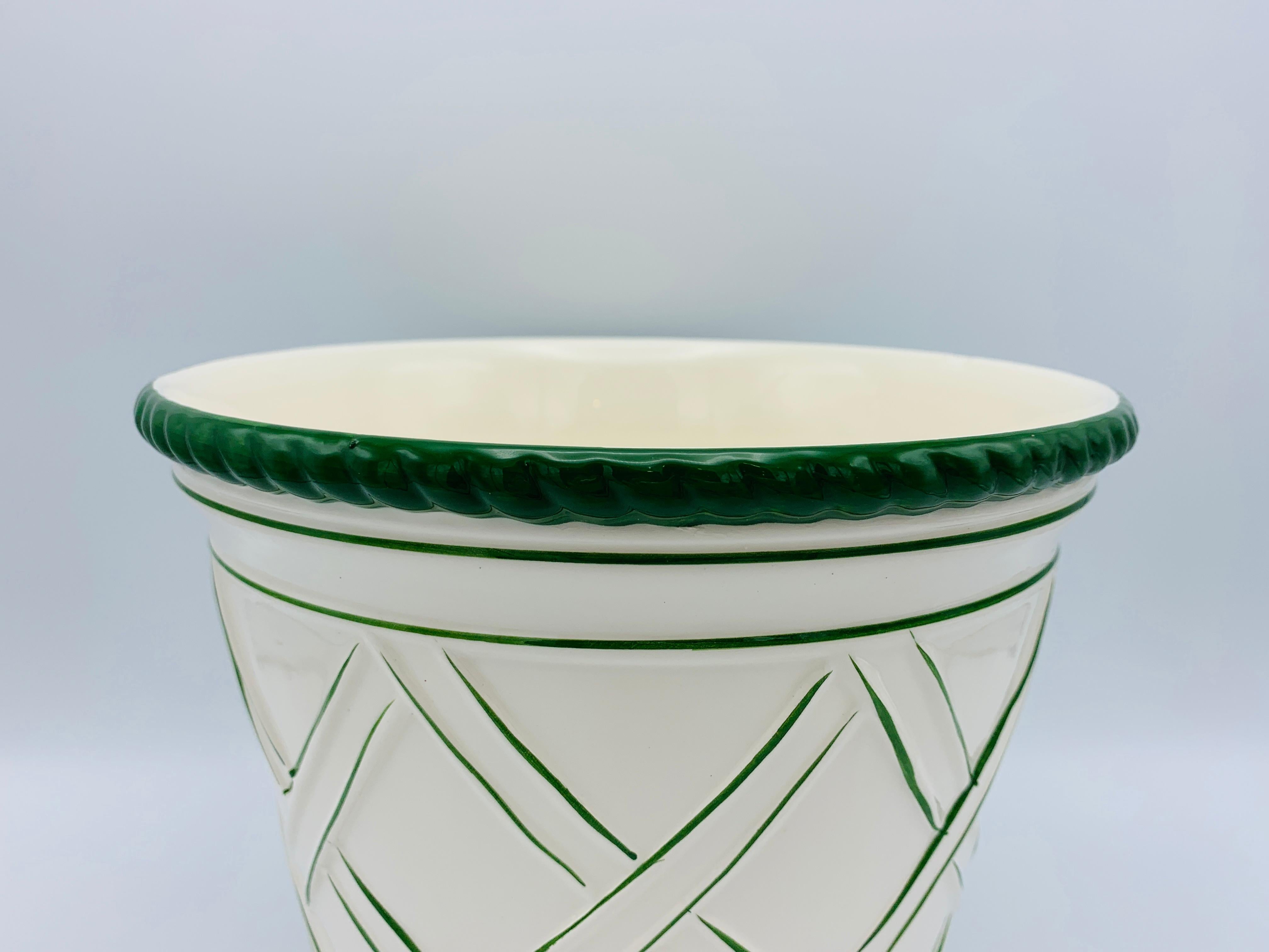 Listed is a fabulous and large, 1960s Italian ceramic cachepot planter. The piece is primarily white with Kelly green lattice work all-over and ridged upper and lower collars. Heavy, weighing 3.7lbs.