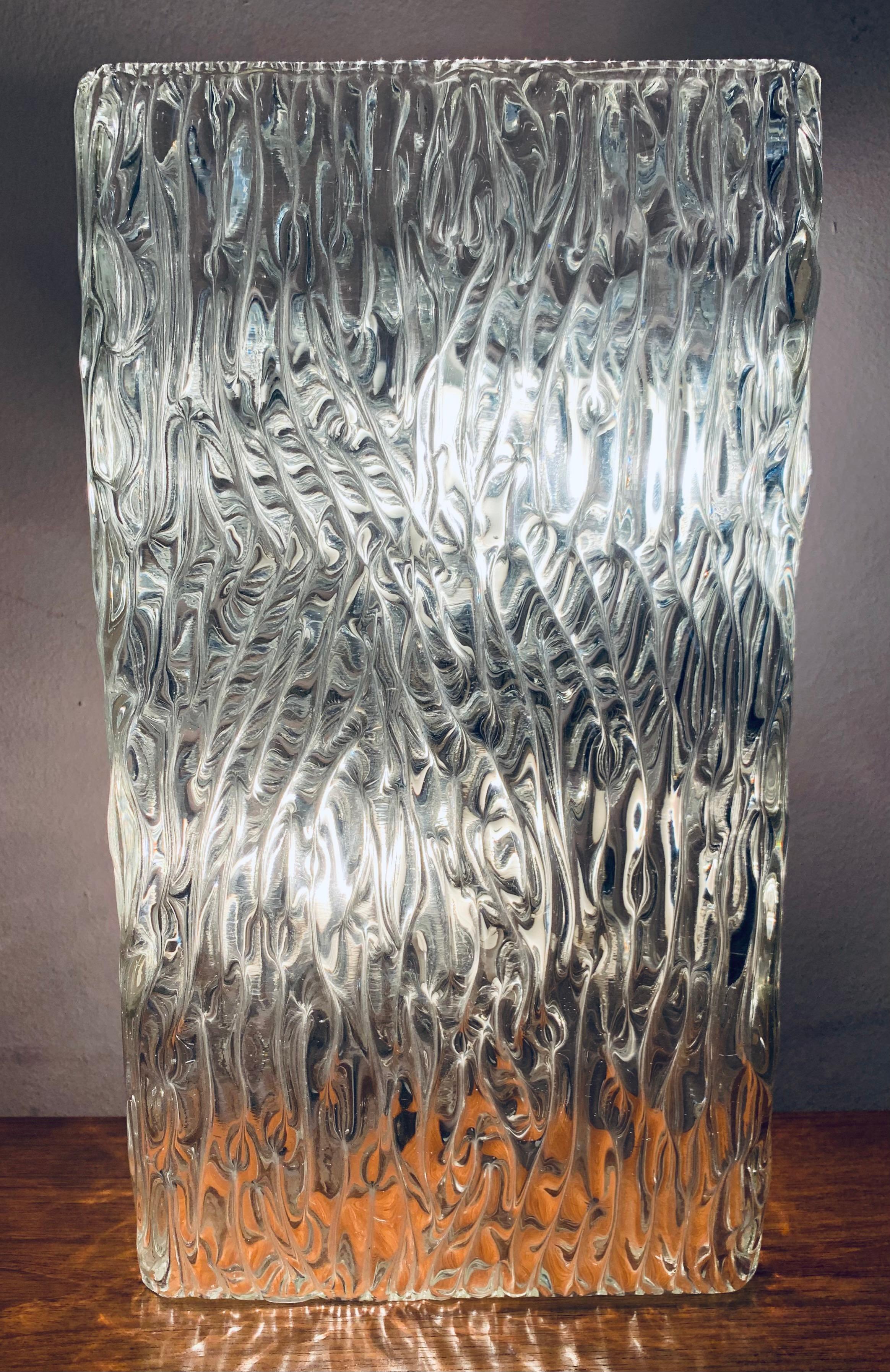 Large 1960s wall light or wall sconce designed by J.T. Kalmar and manufactured by Kalmar Lighting in Vienna, Austria. The sculpted, textured, molded glass has a wave pattern covering its entire outside surface which produces a warm diffused light.