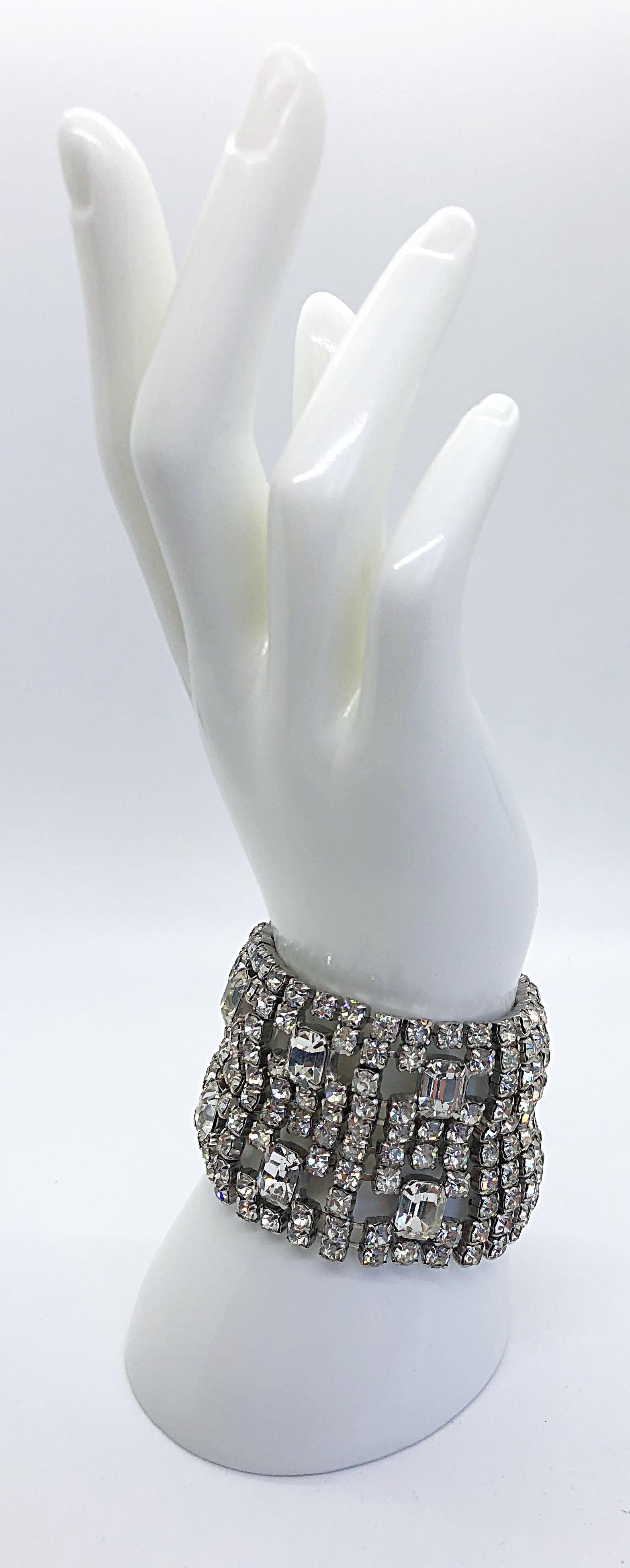 Stunning large rhinestone Hollywood glam bracelet cuff! Add some sparkle to any outfit! Ten rows of rhinestones with six large spread out ones in the center. Intricate etched clasp fastener. Very well made. Can easily be dressed up or down. Great