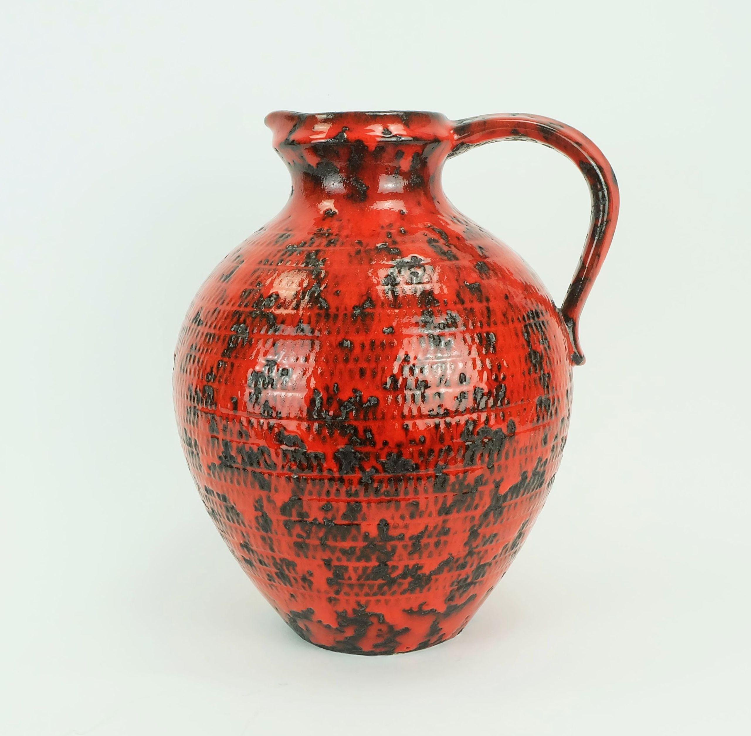 Large 1960s jug vase manufactured by Fohr-Keramik in the 1960s. Relief decor in shiny red and black lava glaze. Marked to bottom 490-30 W-Germany. 

Dimensions in cm:
Height 32 cm, width 28 cm, depth 25 cm.

Dimensions in inches:
Height 12.59