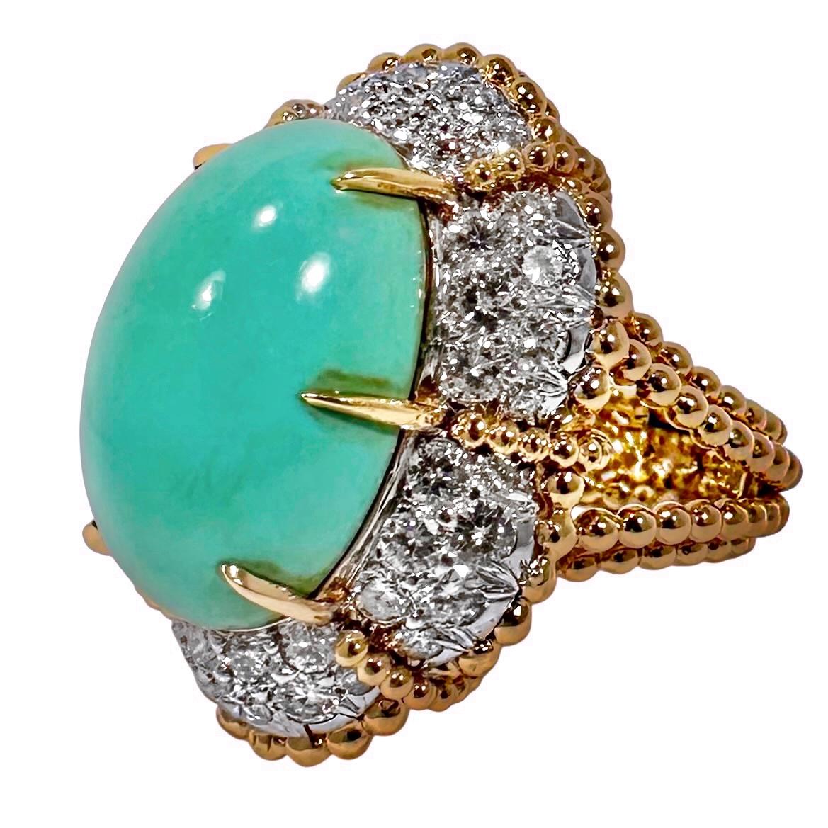 This beautifully designed and expertly crafted 1960's cocktail ring truly is the culmination of the finest craftsmanship and high quality materials combining. At the center is a lovely oval shaped, Persian turquoise cabochon of uniform color,