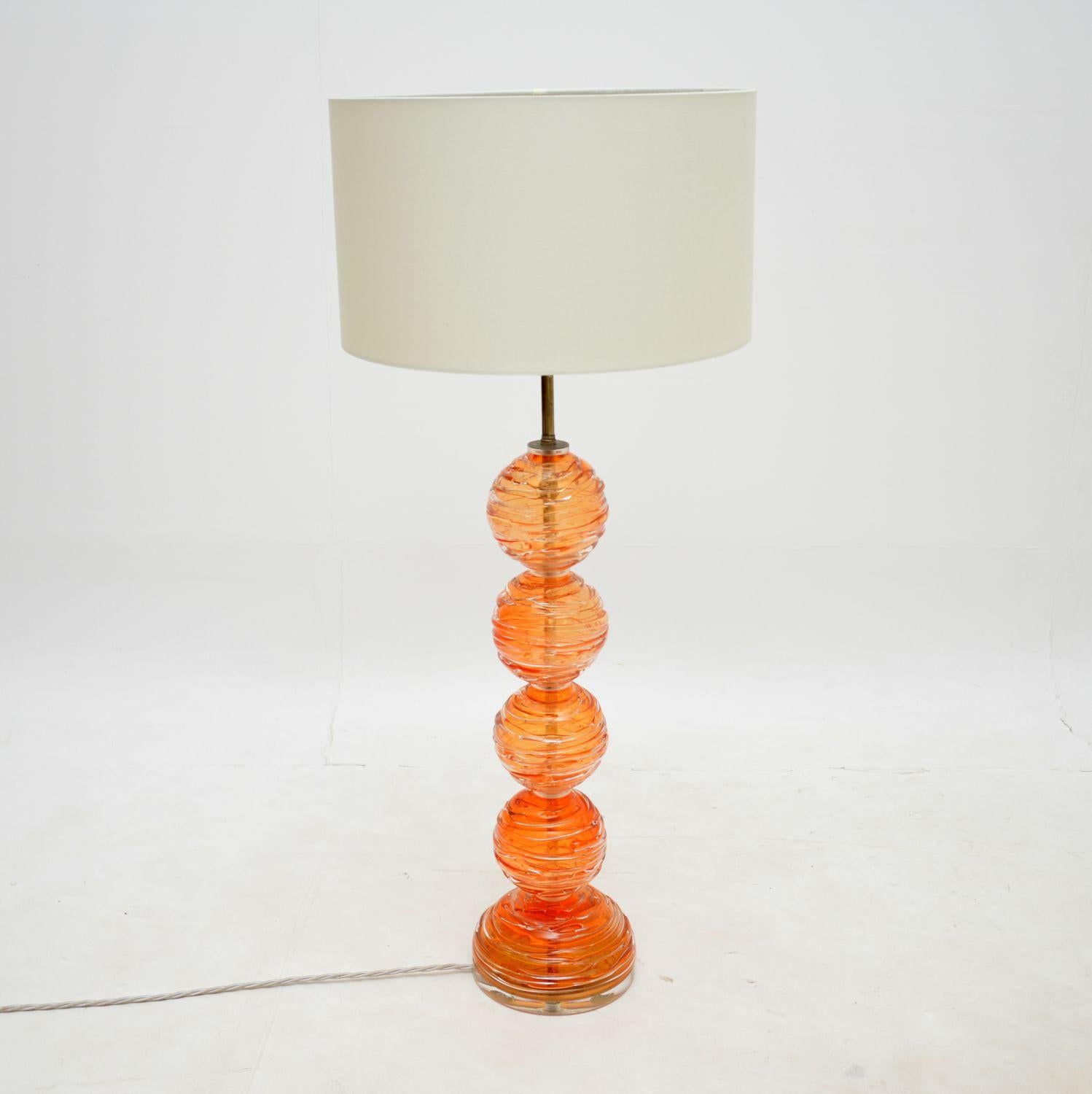 A very large and impressive vintage glass table lamp. This was made in the USA, it dates from around the 1960s-1970s.

The quality is outstanding, with a central column made of beautifully textured orange glass spheres.

The condition is excellent