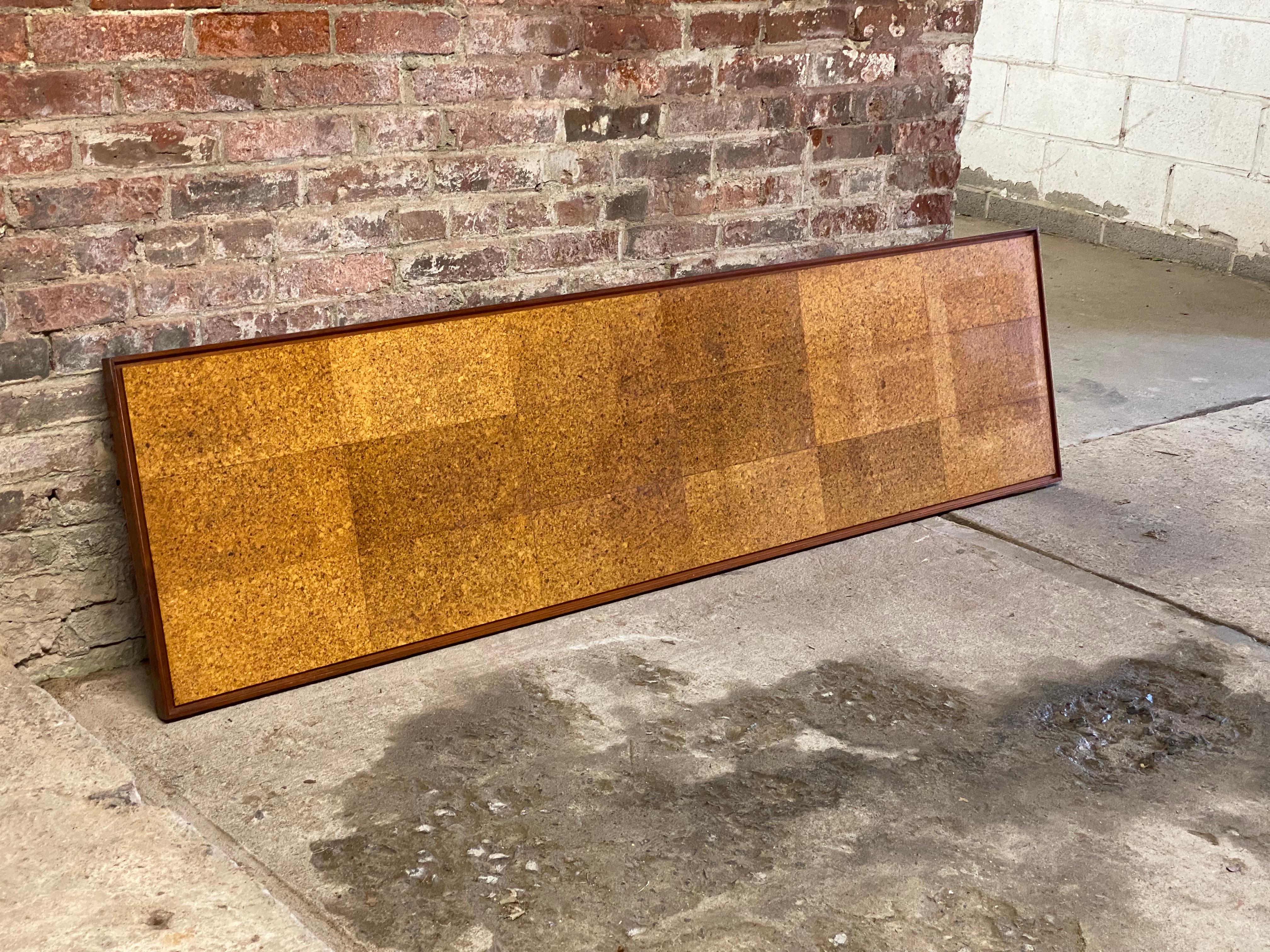 Massive solid walnut framed wall mounted cork board. Circa 1955-60. Two mounting channels on the reverse and backed with old paper. The panel can be used almost anywhere in the home or office. There is no comparison between the visual benefits of
