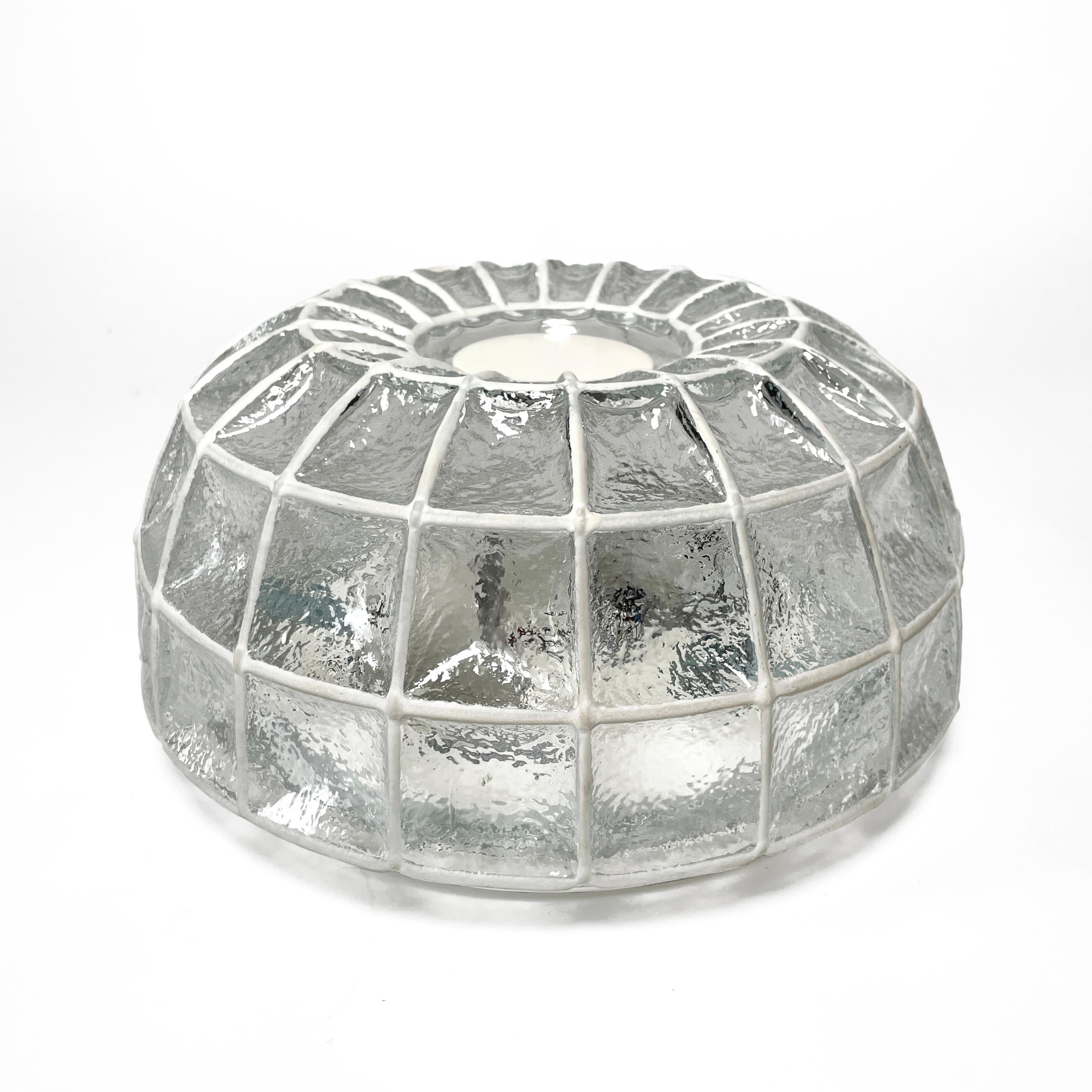 Elegant vintage ceiling or wall light made of iron and clear glass, manufactured by Glashütte Limburg in the 1960s. The lamp has a heavy spider web shaped lampshade made of iron and textured glass and a metal fixture. The lamp impresses with its