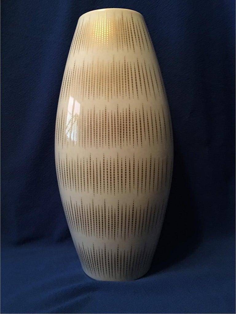 Thomas Porcelain, a part of the Rosenthal Porcelain Group of Germany manufactured this lovely, large white vase with gold stripes. A great decor item in any room.