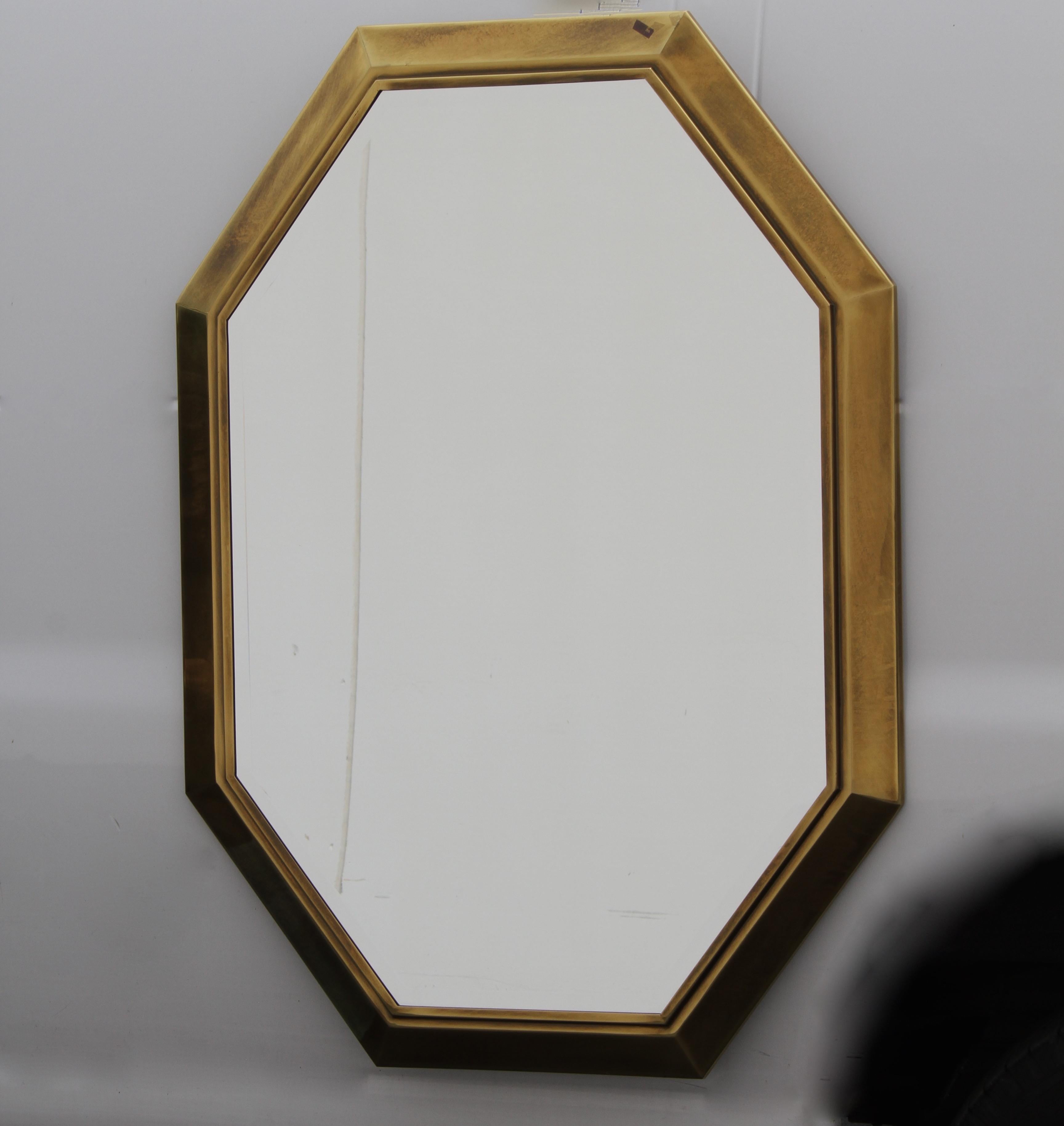 1970s brass Hollywood Regency mastercraft octagonal mirror with 3/4 bevel edge. Glass is in excellent condition, brass has nice applied patina from Mastercraft. Very heavy! Label.
