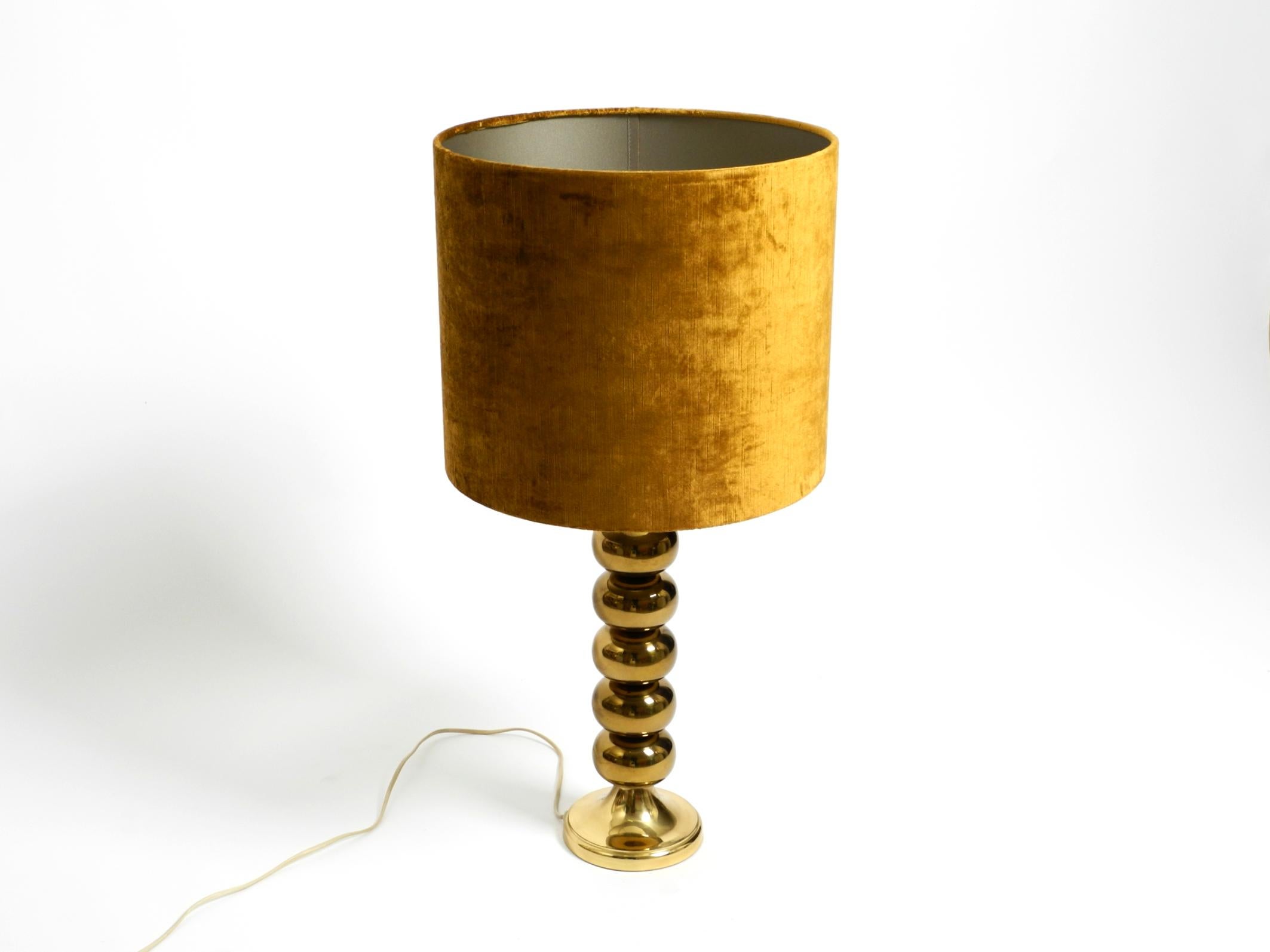 Very rare large 1970s brass table lamp with a new velvet shade by Aneta Växjö.
Made in Sweden. A wonderful, very elegant Swedish design in original vintage condition.
The lamp is made entirely of brass. It has a beautiful new lampshade made of gold