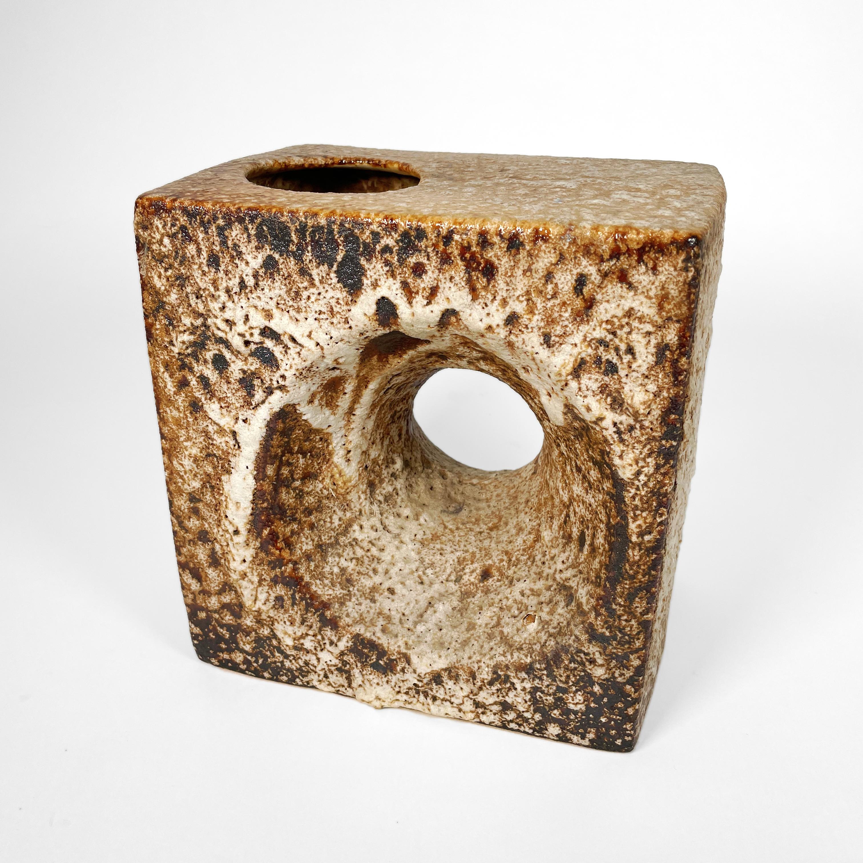 This large and stunning vase in the shape of a cube was designed and produced by Marius Van Woerden for his own company Vest Keramiek during the 1970s. 
The cubic vase has a big hole in it, which is so typical for Marius Van Woerden's design and is