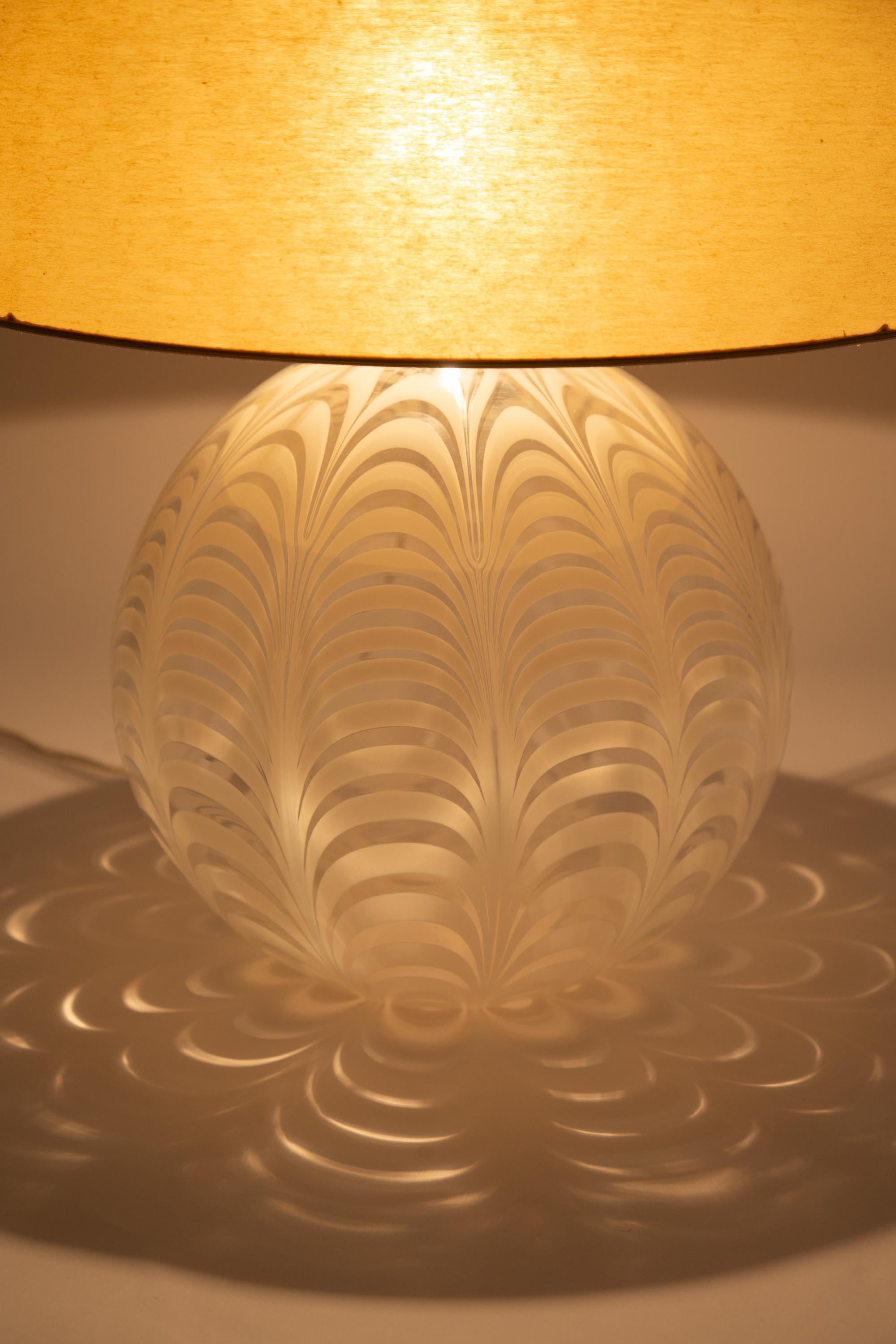 A large blown glass, 'phoenician' pattern, table lamp. Murano, 1970s.

Retains original laminated linen shade in good condition. A smaller custom made shade in fabric or parchment can be made to order.

Base Dimensions: 39 x 39 cm
Shade Dimensions: