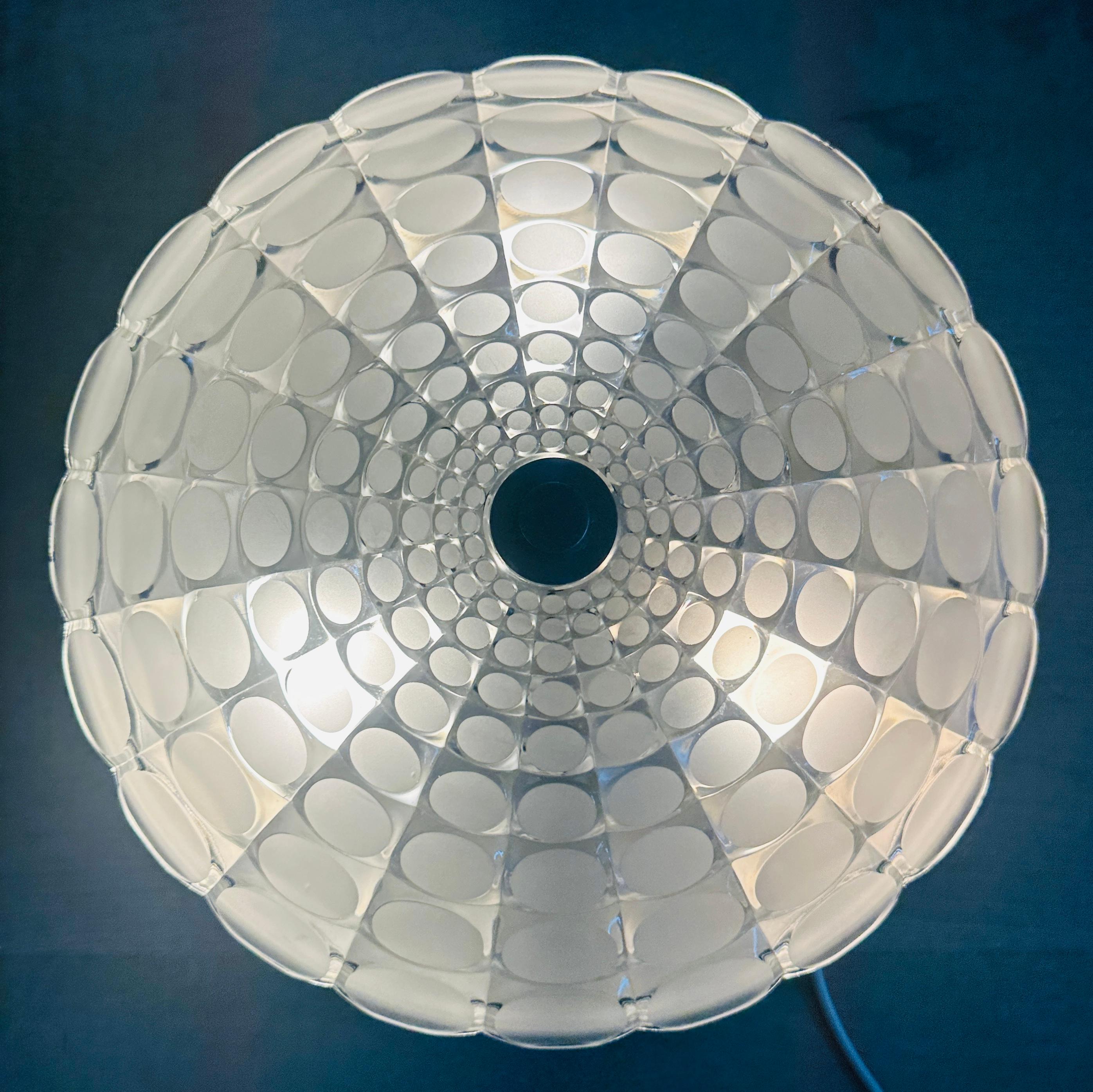 A bold and sculptural flush mount ceiling light from 1970s Germany, by Peill & Putzler. This impressive piece features a large, domed glass shade with a striking geometric pattern made up of sandblasted oval lozenges arranged concentrically, forming