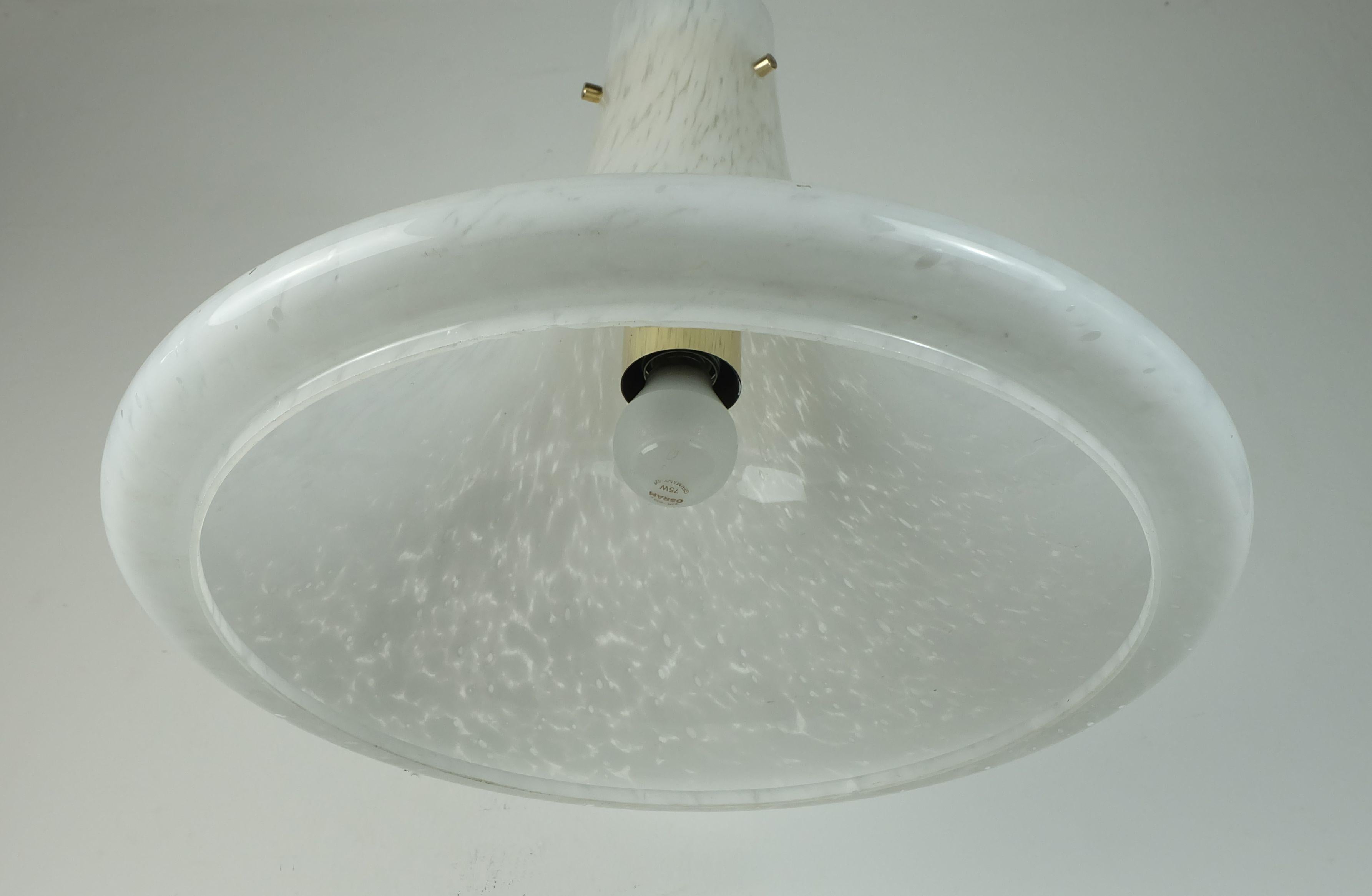 Mid century pendant light manufactured by Glashütte Limburg in the 1970s, model no. 4234. Large trumpet-shaped shade made of white opaline bubble glass. The tubular inner bracket is made of brass. Black electric wire and black canopy. Holds 1 light