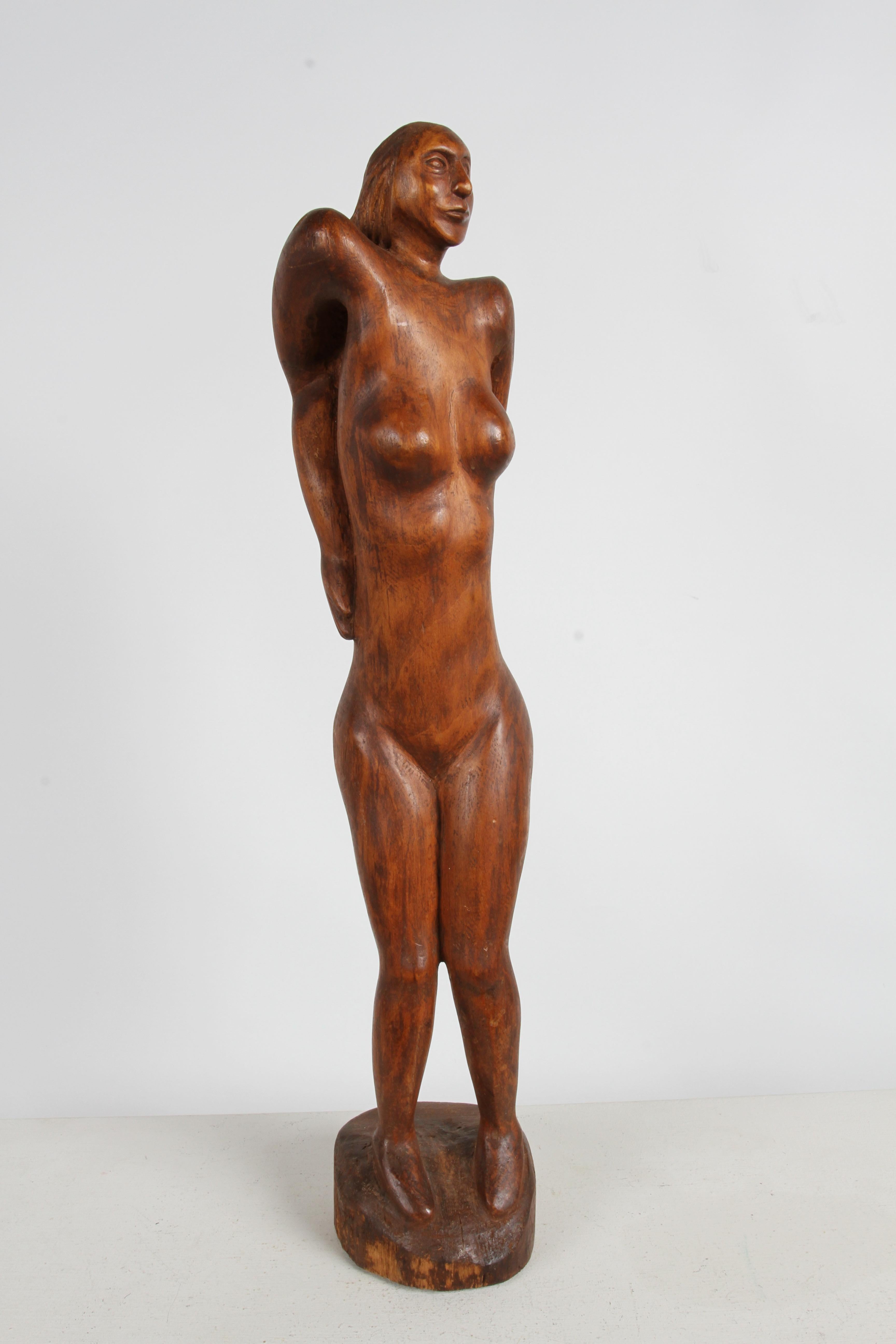 Late 60s or early 1970s Mid-Century Modern organic hand-carved standing abstract nude female form sculpture. Tall sculpture at 27.63