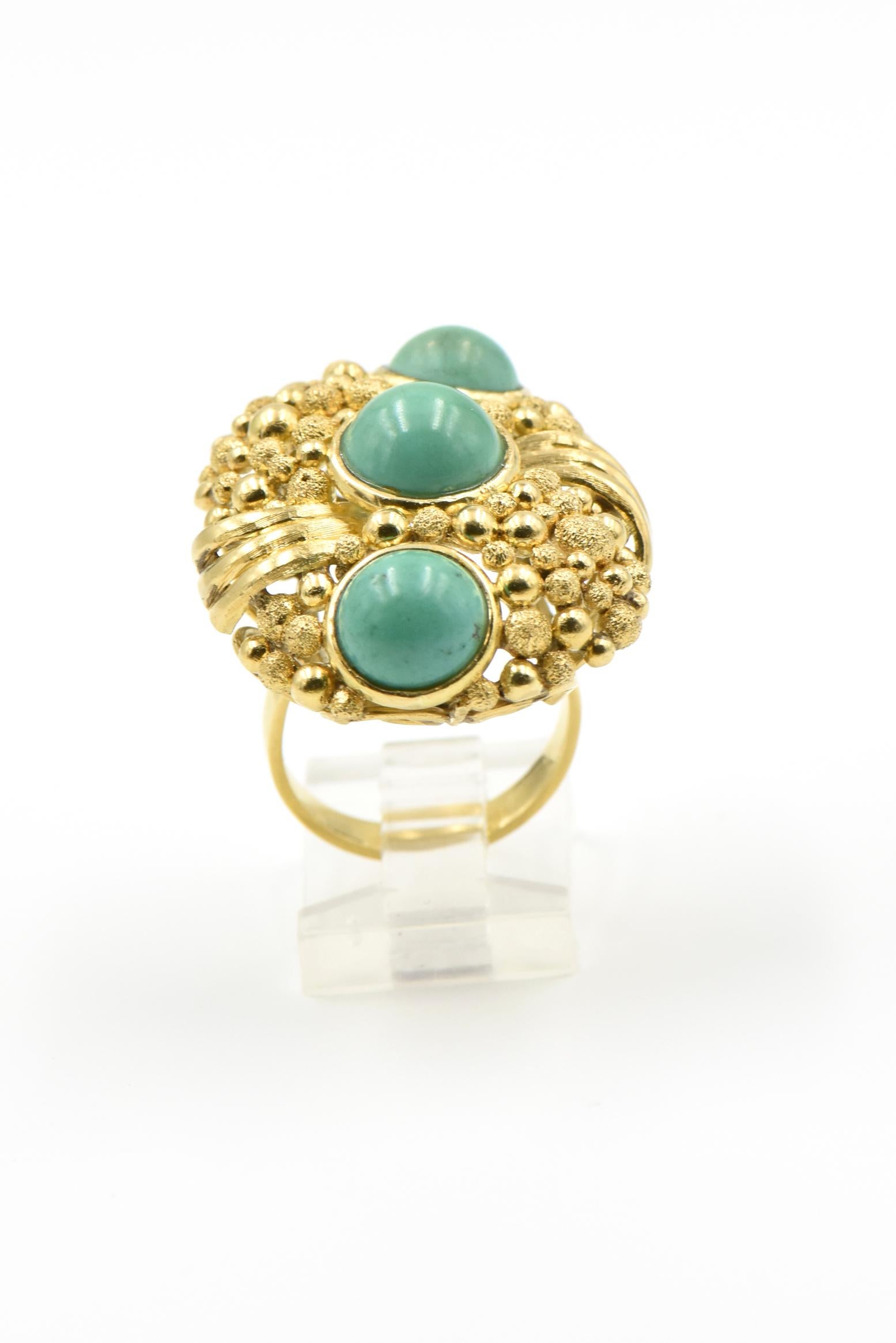 Large oval 18k ring made of textured and smooth bubbles that cover the surface of this impressive ring. Three cabochon turquoise pieces are bezel set down the middle to add great contrast. 

The ring is 1