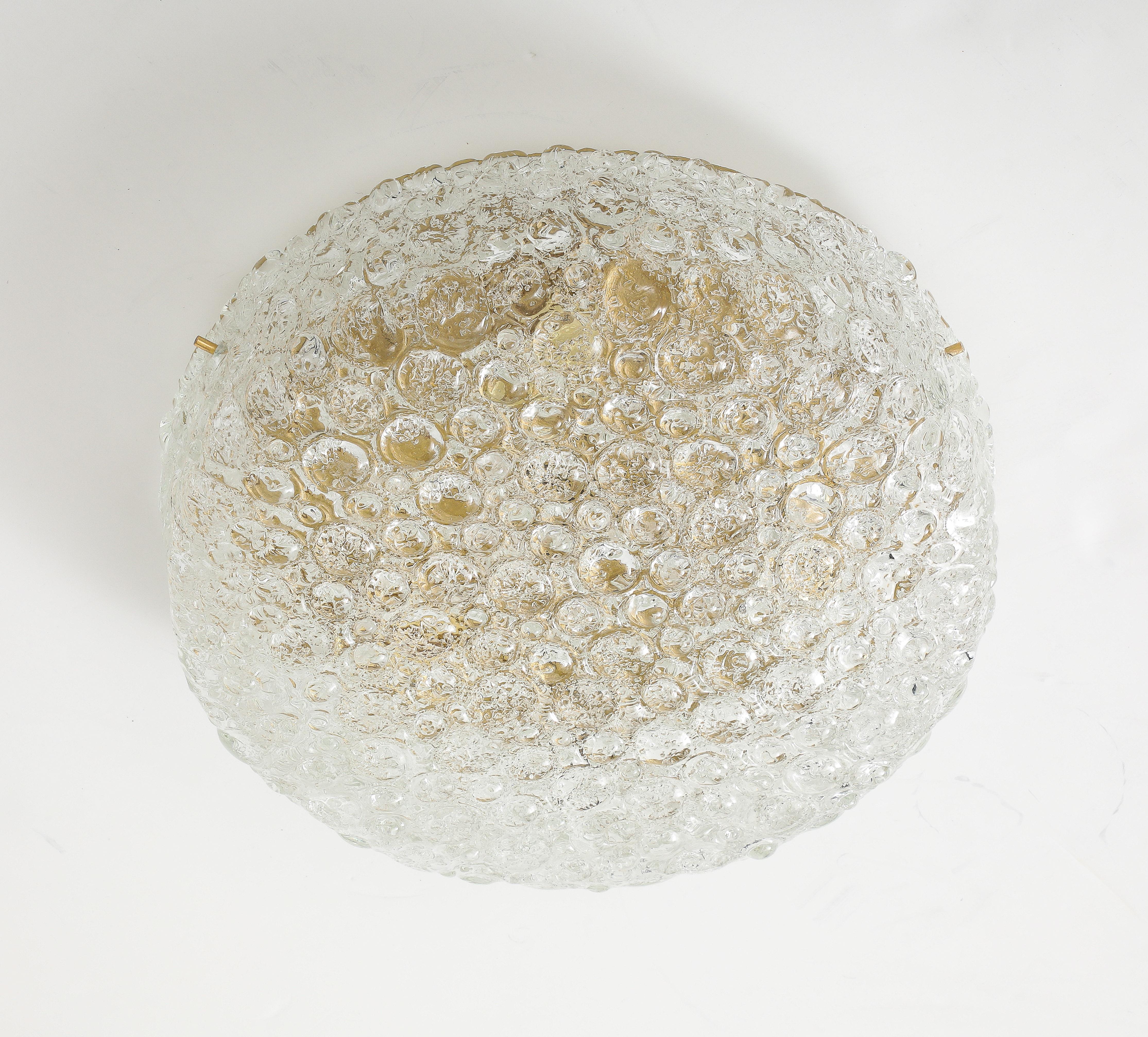 1970's Large Murano glass flush mount / ceiling fixture by German Manufacturer Hillebrand.
The Murano glass shade has a textured ice bubble appearance and when it is  illuminated gives a warm welcoming glow.
The glass shade is held place by three