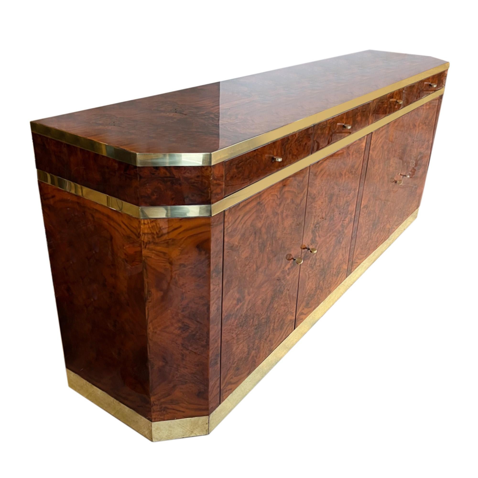This is an amazing midcentury sideboard designed by Jean-Claude Mahey in the 1970s. 

It has ample storage space and a great surface for a pair of large table lamps, a generous vase and or a decorative surtout de table. 

Made from walnut veneer