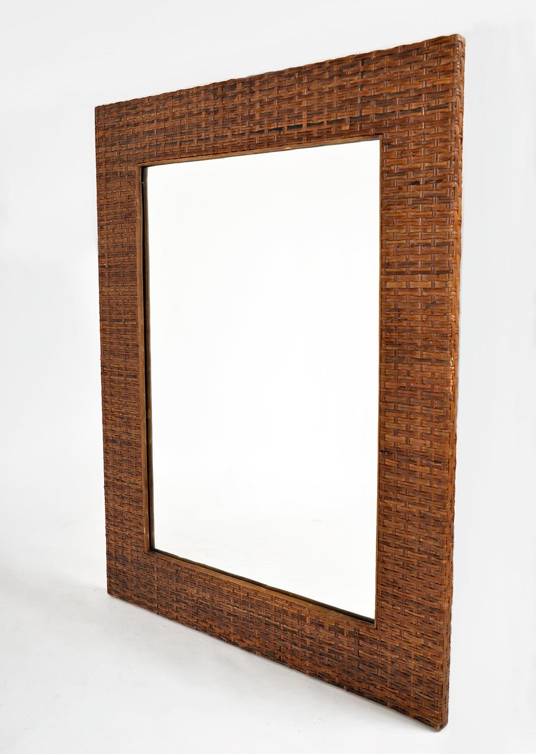 This incredibly stylish 1970s rectangular wall mirror has the richest of colours, the wide frame made from wicker woven split cane with an inner bamboo frame around the mirror. Measuring over 3 feet tall, this impressive mirror has a 13cm deep
