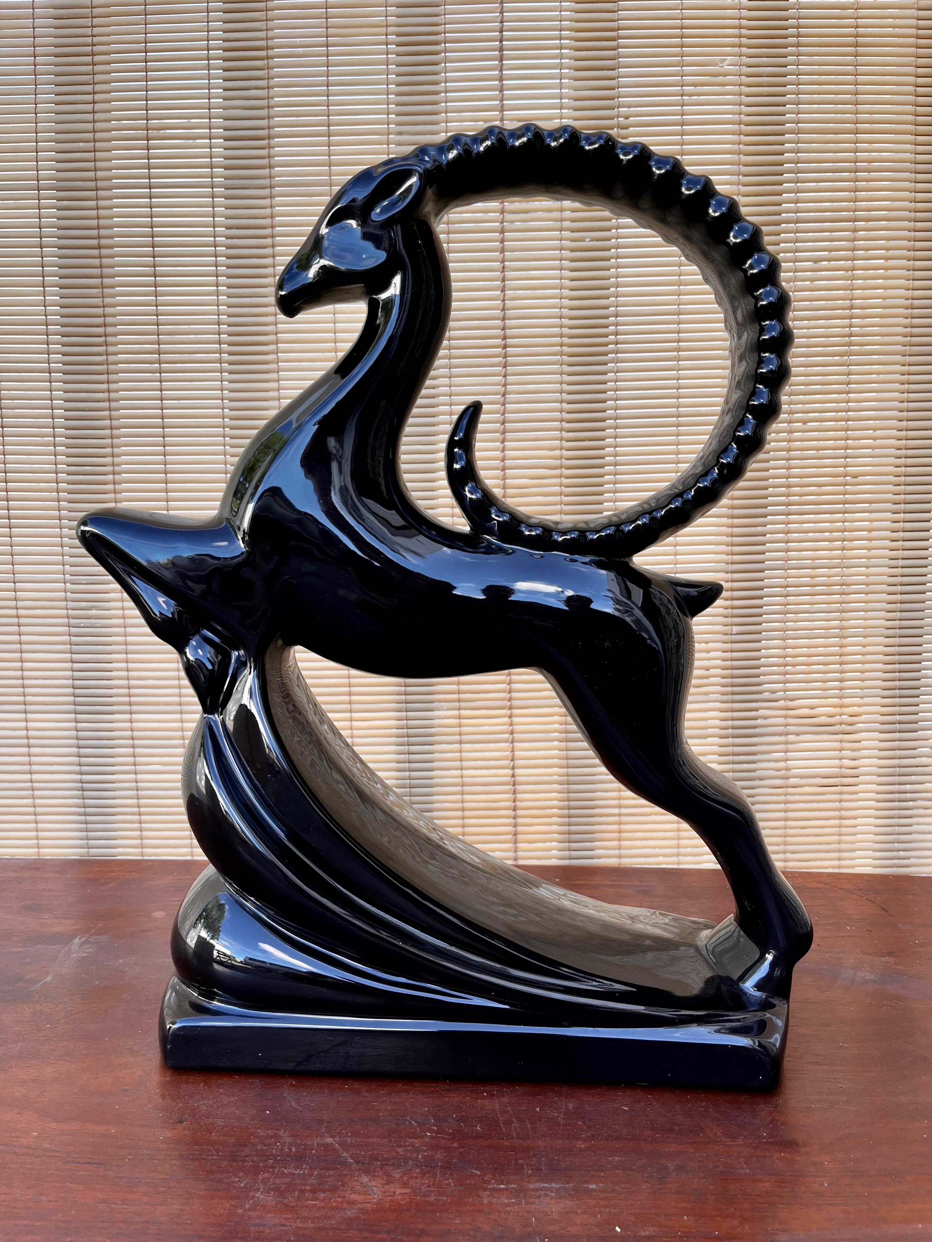 Large 1980s Art Deco Revival Royal Haeger black leaping Gazelle Figurine. circa 1980s 
Features a large size hollow molded gazelle image with a high gloss black glaze finish in an Art Deco inspired Style. 
In excellent near mint original