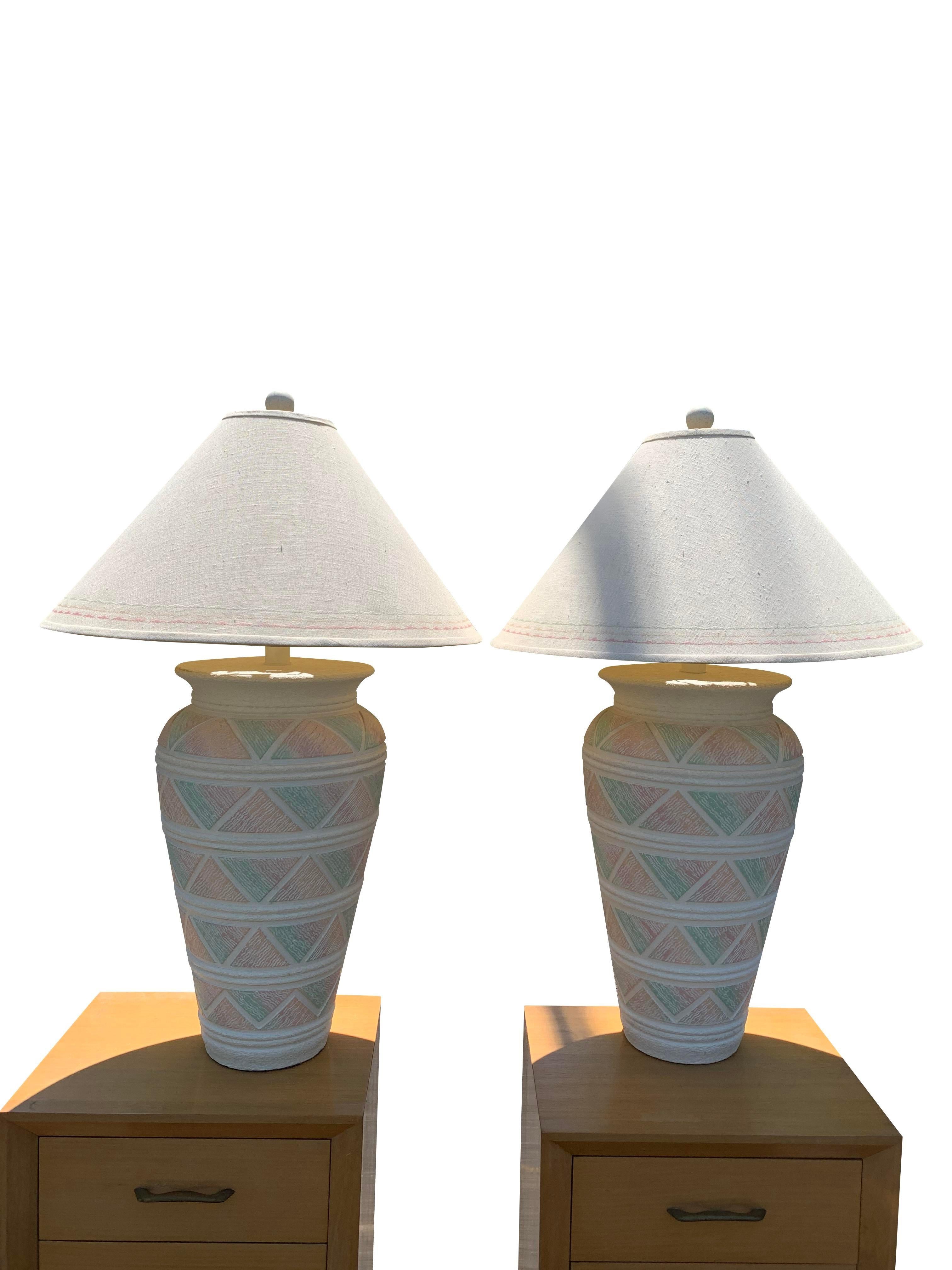 Large Vintage Southwestern Deco Modern Style Table Lamps in Pink Green Pastels - A Pair. These large ceramic lamps feature a beautiful blend of pink and green pastels, creating a captivating and eye-catching piece.

Key Features:
Vintage Charm: