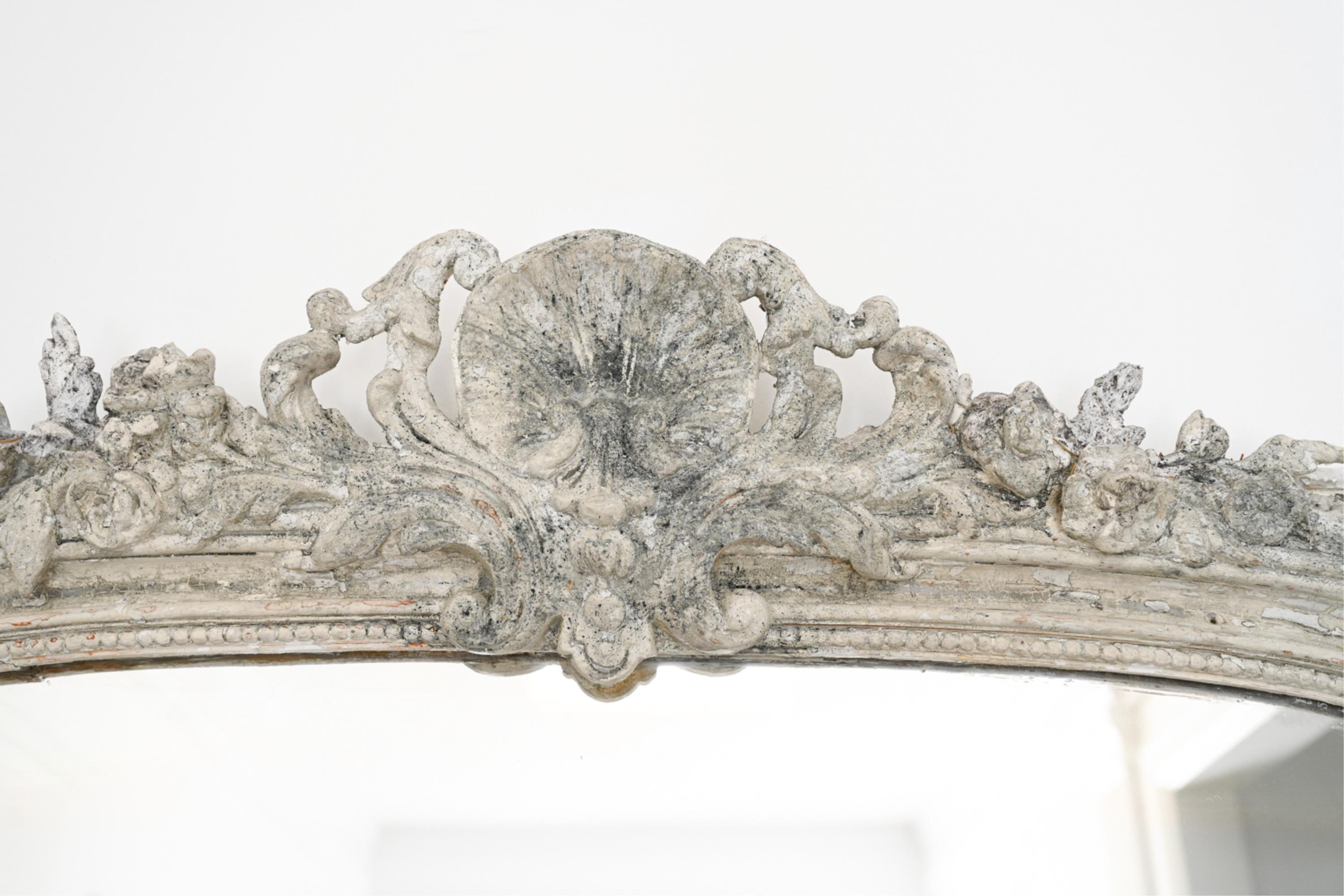 A rare impressive large scale antique Italian mirror, originally gilt, now with many layers of paint and faux antiquing.  Mirror has beautiful carved details, perfect as a floor or full length mirror with height and width.  Back with new support for