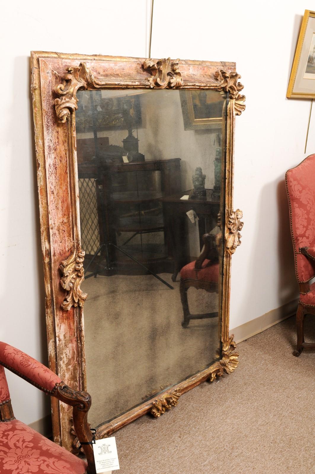  Large 19th C Continental Rococo Style Mirror w/ Stripped Gilt /Red Gesso finish In Good Condition For Sale In Atlanta, GA