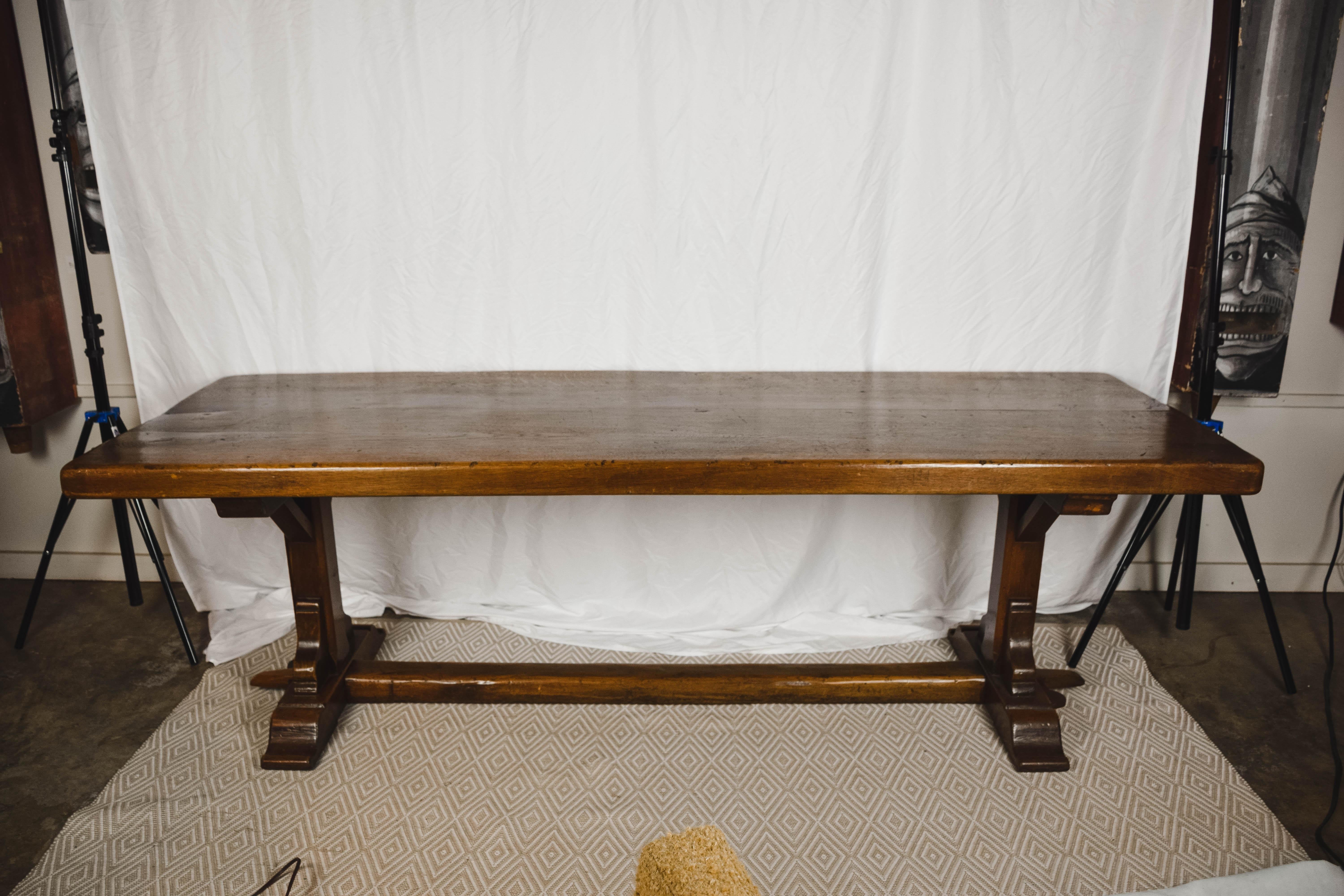 Found in Northern France, this 19th century oak refectory or monastery table features a three-inch thick top made from three planks of wood with a gorgeous wood patina that can only be achieved with age. The table rests on a sturdy trestle base