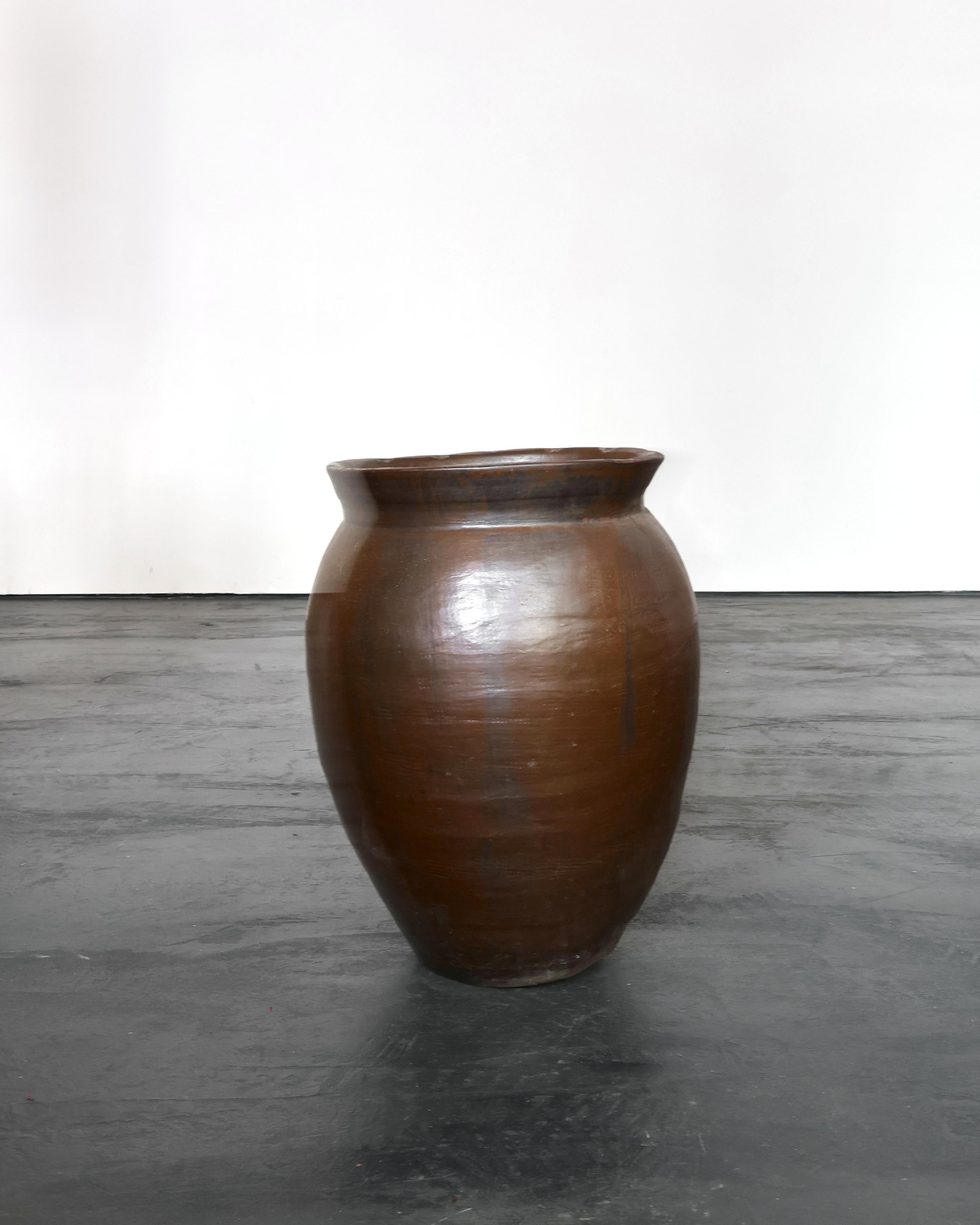 A large mid 19th C. Japanese glazed terracotta vessel originally used for the storage/transportation of miso.

Due to the vessels utilitarian past it has developed a rich patina over the 100 + years of regular use.