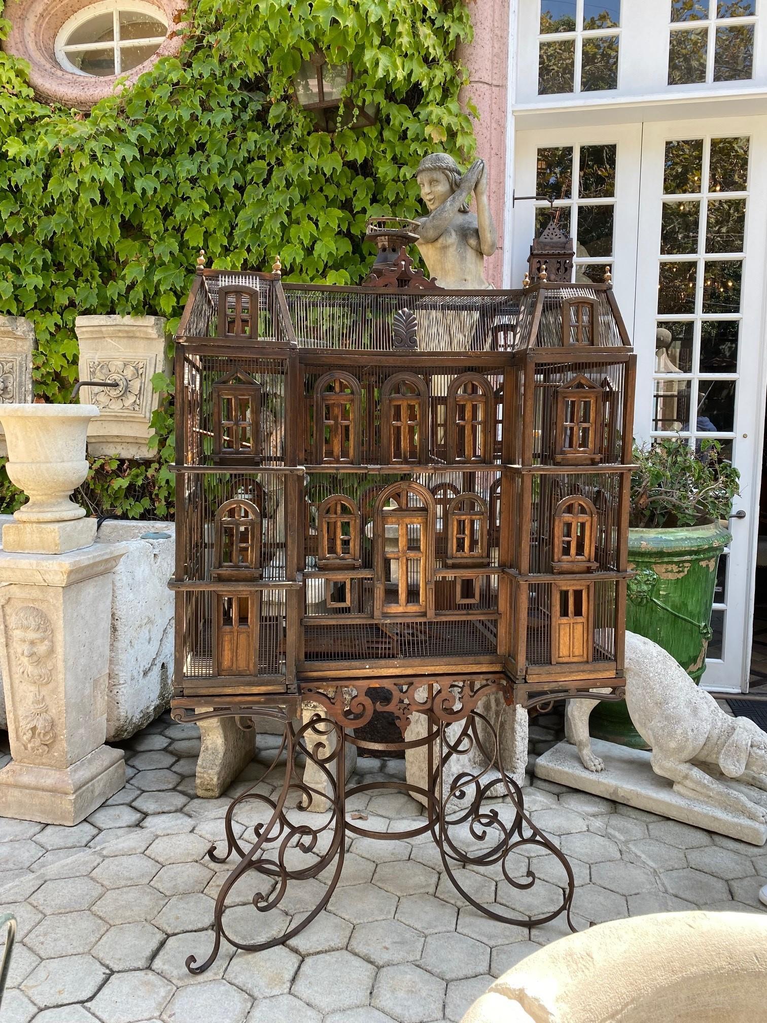 Rare and imposing Chateau large 19th century walnut hand carved and hand forged crafted Birdcage from Normandie on the original hand forged iron stand. Hand carved wood pieced fitted together with attention to details proportions and elevations. A