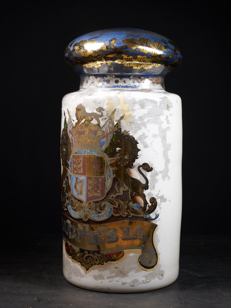 Here is a wonderful decorative late 19th century pharmacist hand blown dispensing/display glass jar of considerable size. The jar is reverse painted by hand with a white ground and gilt detailing. There is some loss to the paintwork adding to its