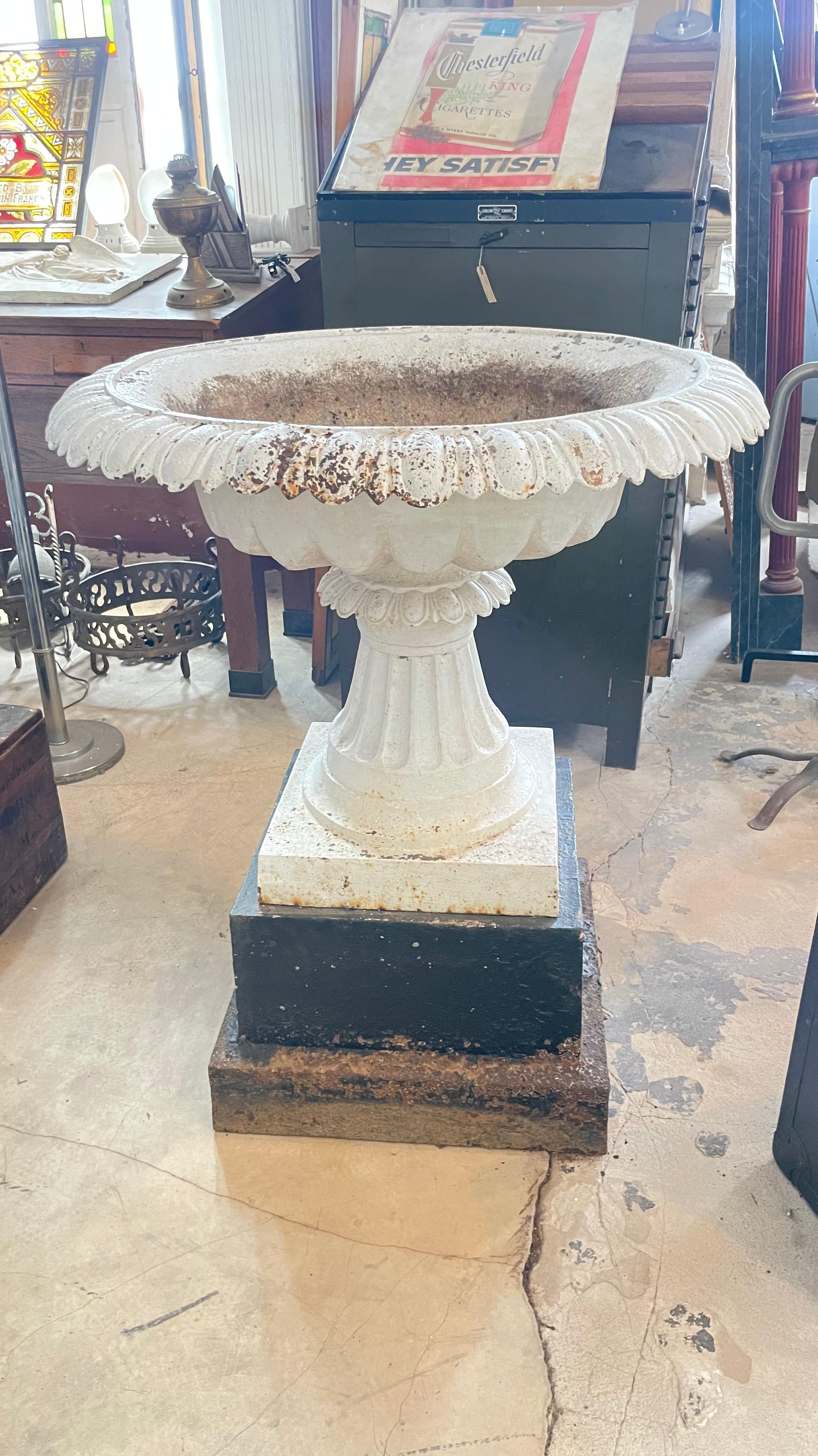 Substantial, cast iron, Victorian garden urn on pedestal.  Complete and original.  Classical Tazza form. From the. last quarter of the 19th century.  
Base measures 22