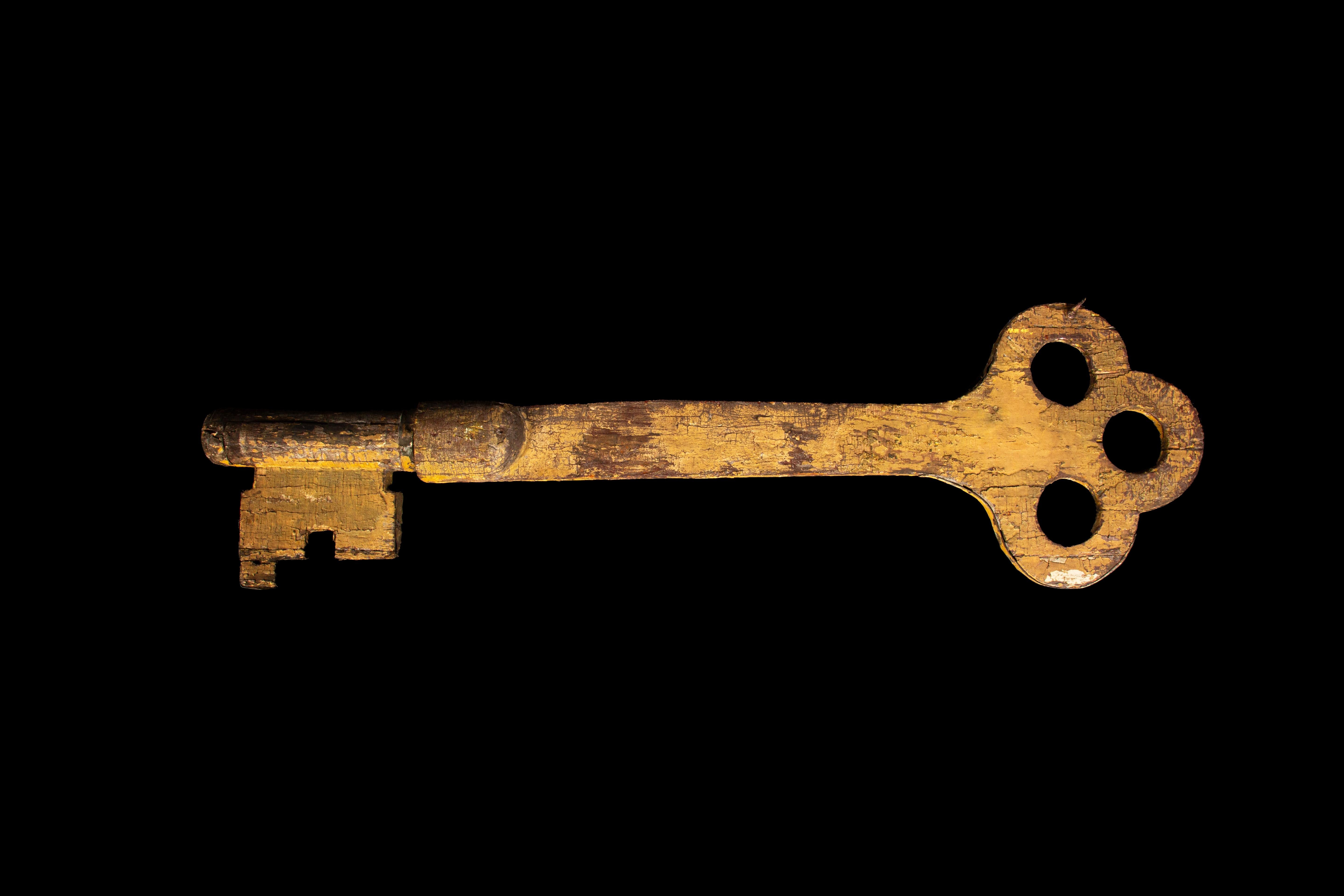 This 51-inch long locksmith key trade sign from the 19th century is a remarkable piece of craftsmanship, embodying the era's artisanal pride. Made from Painted wood, it showcases a weathered patina that highlights its age and historical