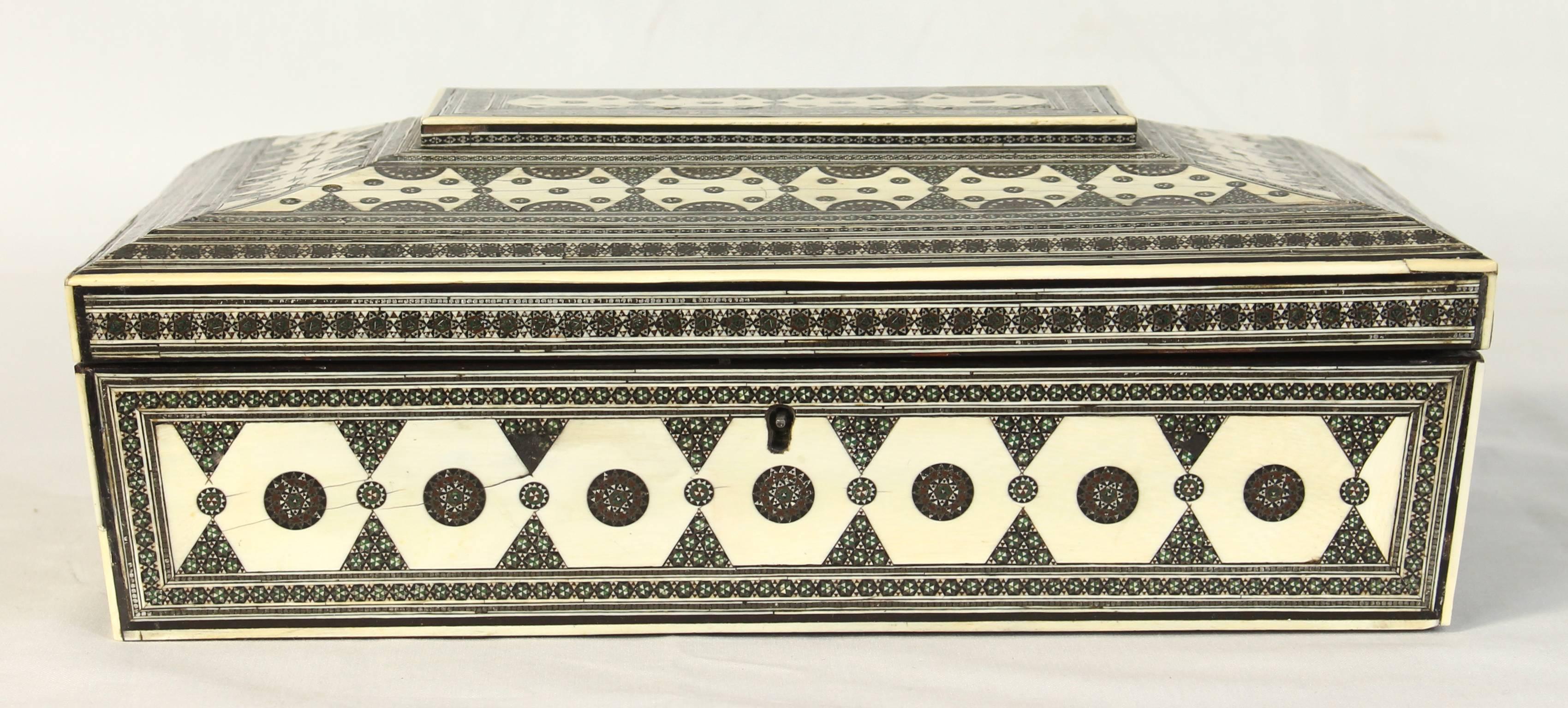 A large early-19th century sarcophagus shape Anglo-Indian bone and sadeli mosaic sewing box fitted with various compartments and cotton reels.