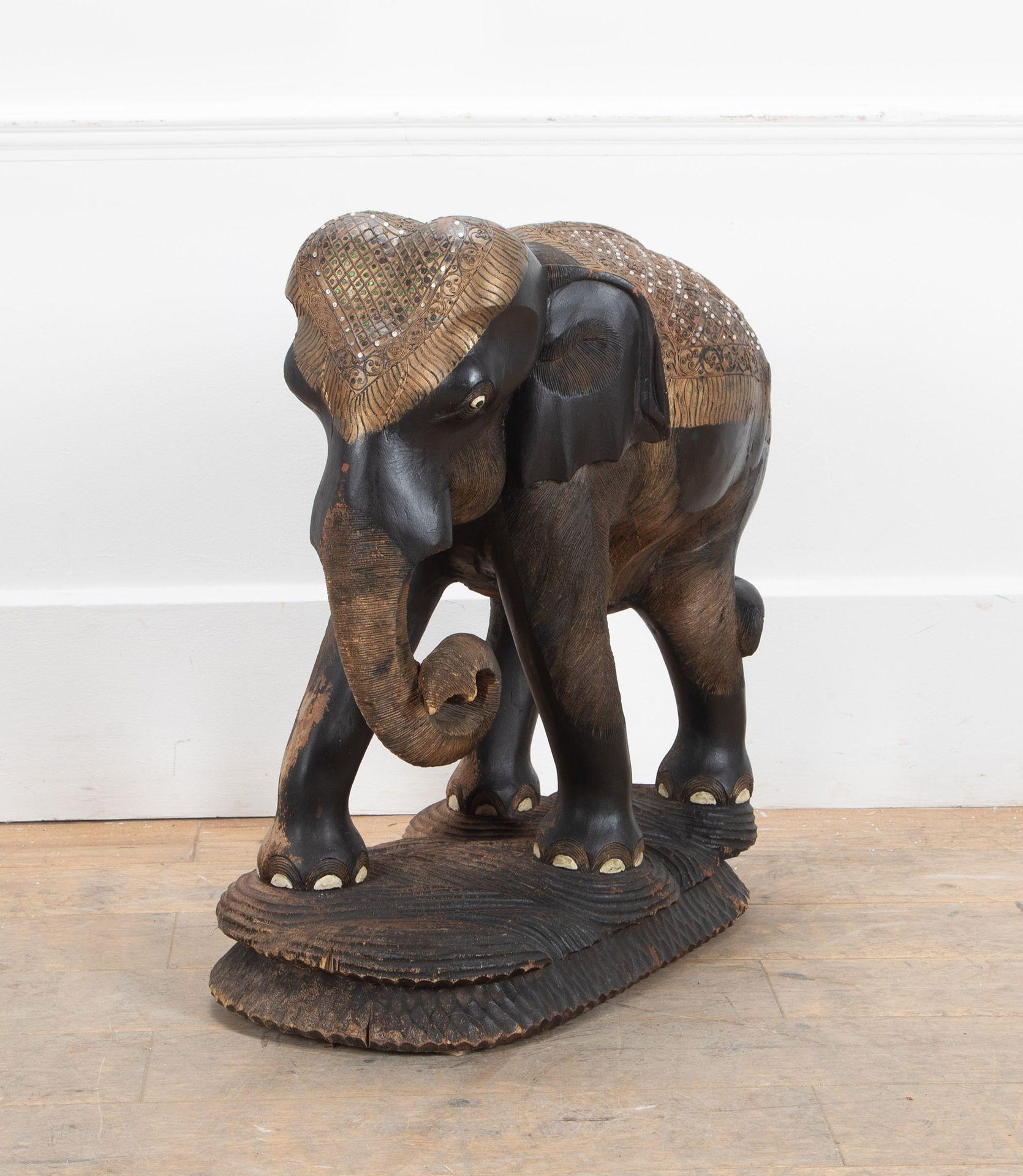19th Century monumental carved wooden elephant. 
Intricately carved (down to the hairs on his legs) out of one enormous piece of wood. This elephant is a rare and one-of-a-kind find. 
Weighs in at an impressive 36kg.
