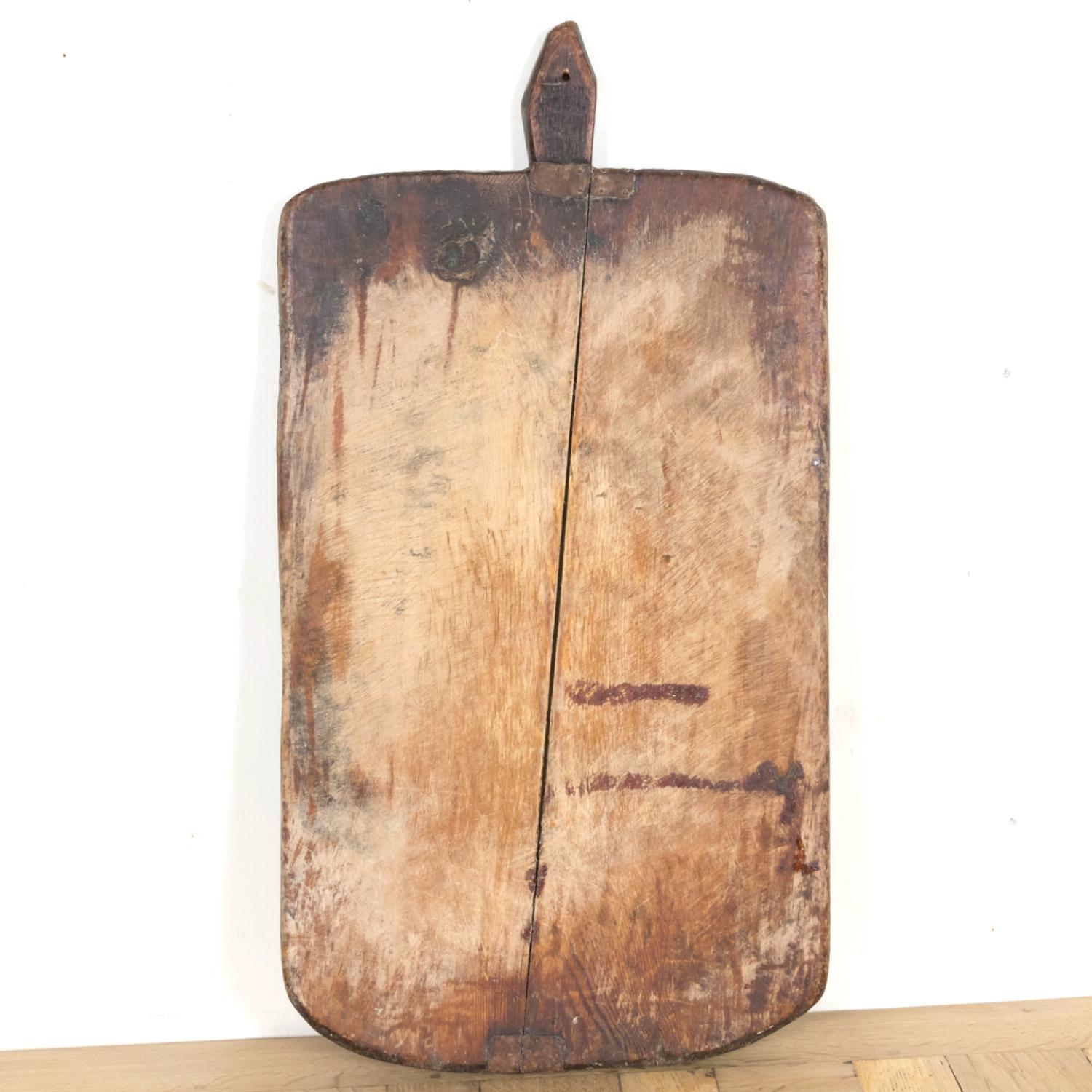 A large 19th century antique French Country cutting board or chopping board, circa 1870s, having a timeworn patina on both sides, showing knife marks and darkening that happens only after decades of use. This beautiful antique board has horizontal