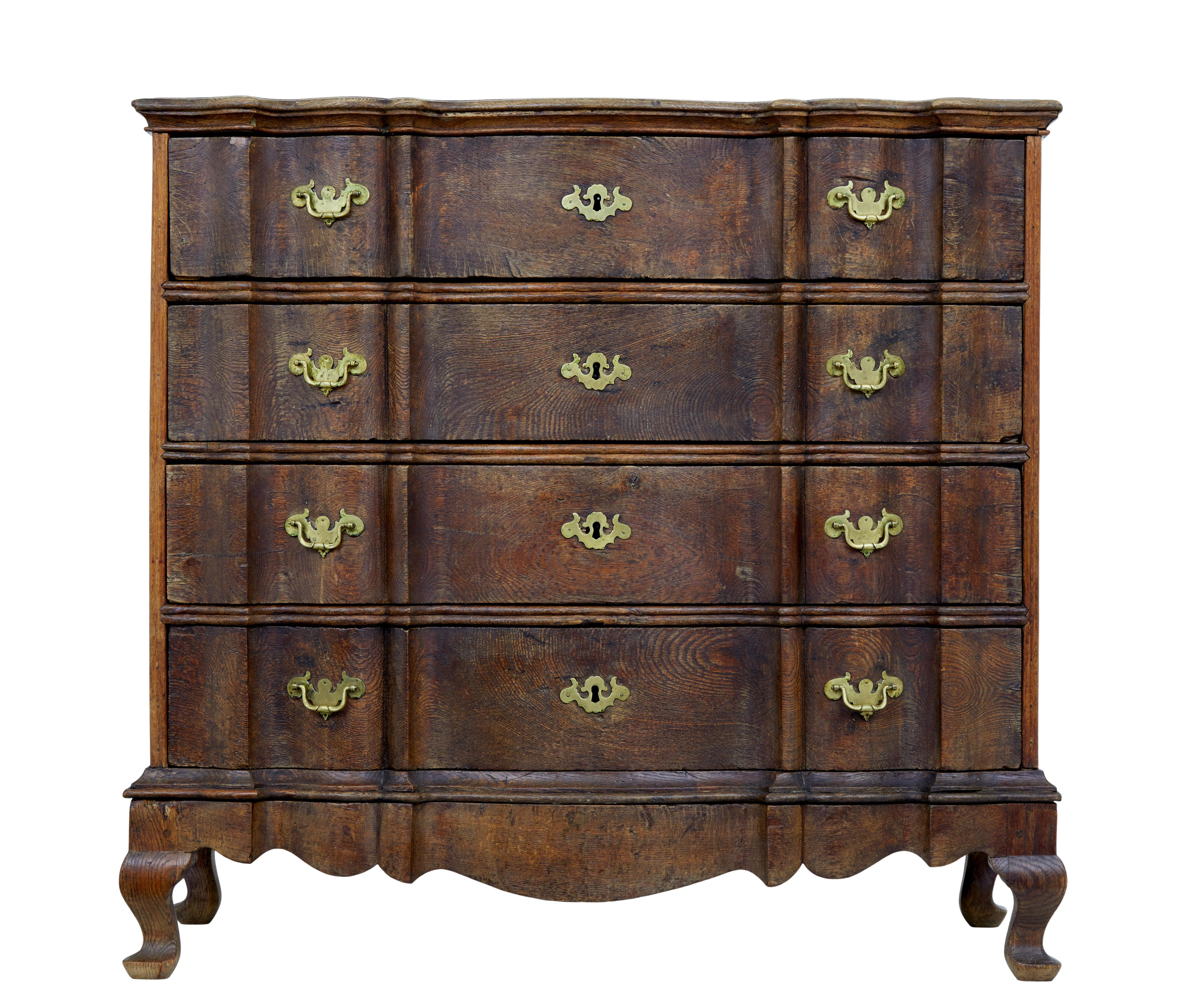 Large and impressive mid-19th century danish commode, circa 1840.

Solid oak construction, comprising of 2 parts with the main body sitting on a separate base. Fitted with 4 drawers with shaped drawer fronts. Each fitted with brass