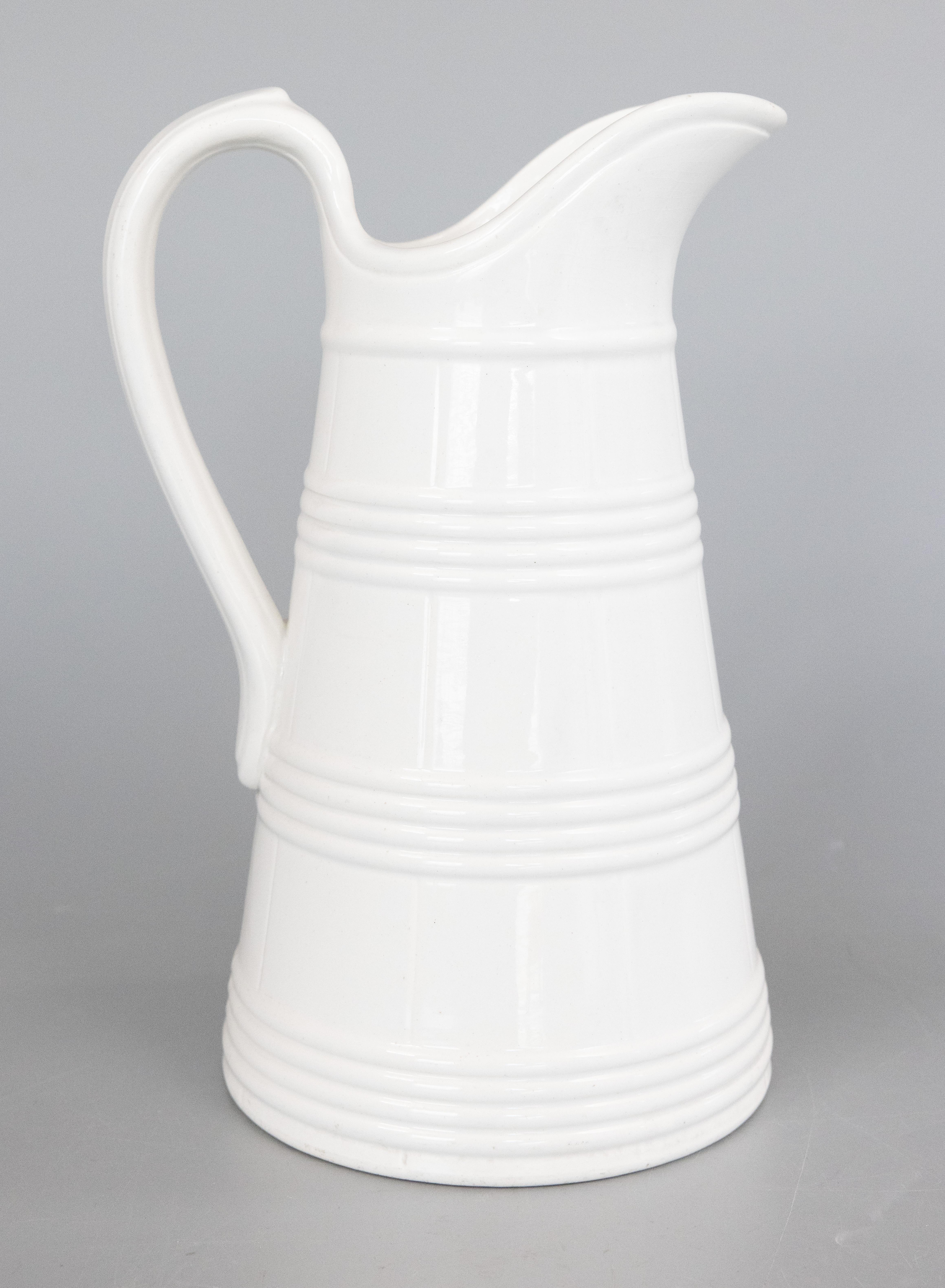 Un'incantevole brocca belga di grandi dimensioni in pietra ferrosa bianca, risalente al 1880 circa. Realizzato da Boch Freres Keramis La Louviere, in Belgio, firmato sul retro. Questa caraffa di qualità è di grandi dimensioni, con un'altezza di 13.5
