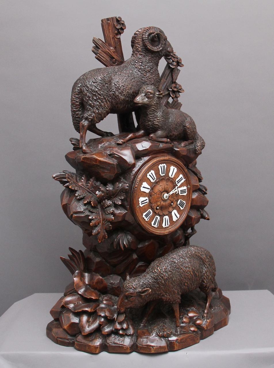 A large and impressive 19th Century walnut black forest mantle clock, the clock dial located at the centre within a rock face surrounded by various foliage with a sheep below and a further sheep and ram above. Lovely crisp carving and in excellent