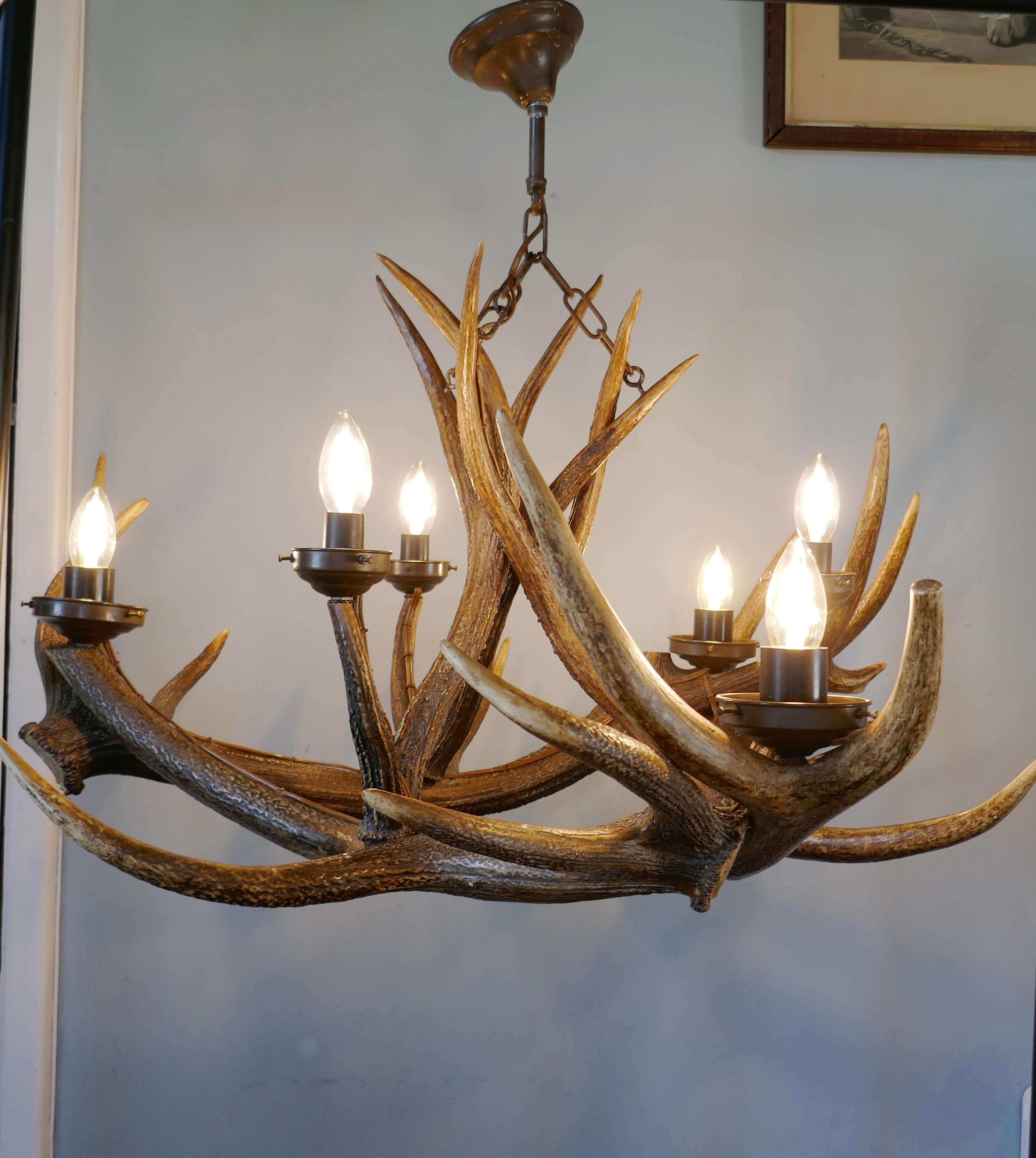 Very large 19th century Black Forrest stag antler hanging chandelier hunting lodge. 
 
This is an imposing and unusual piece, the chandelier was made circa 1870, it has been converted to electricity by surface wiring with no ill effects to the