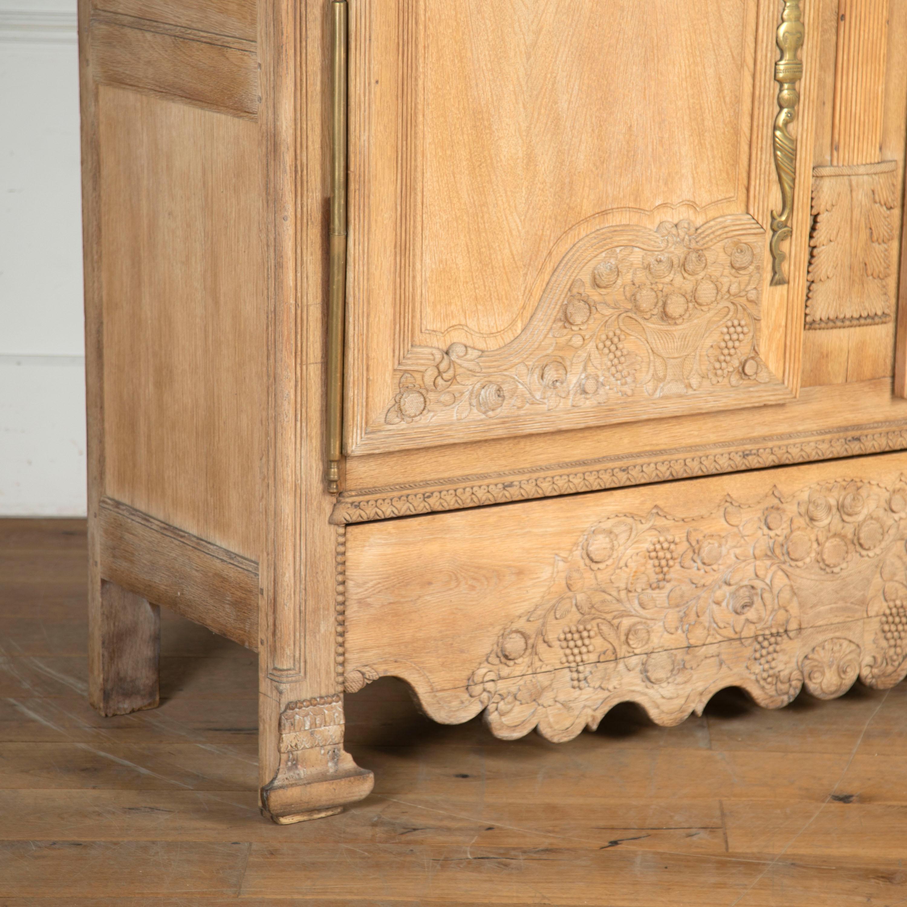 Large 19th century marriage armoire from Normandy. 

This fine quality hand-carved bleached oak armoire has been profusely carved with flowers and grapevines to represent a long, happy and fruitful marriage.

Fitted inside with three shelves,
