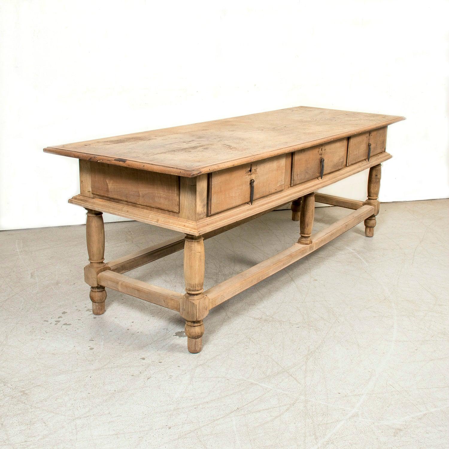 An impressive 19th century Spanish bleached oak island or work table from the Catalan region, circa 1880s. Exuding rustic elegance and old-world craftsmanship, this solid oak work table features a beautifully weathered bleached finish that