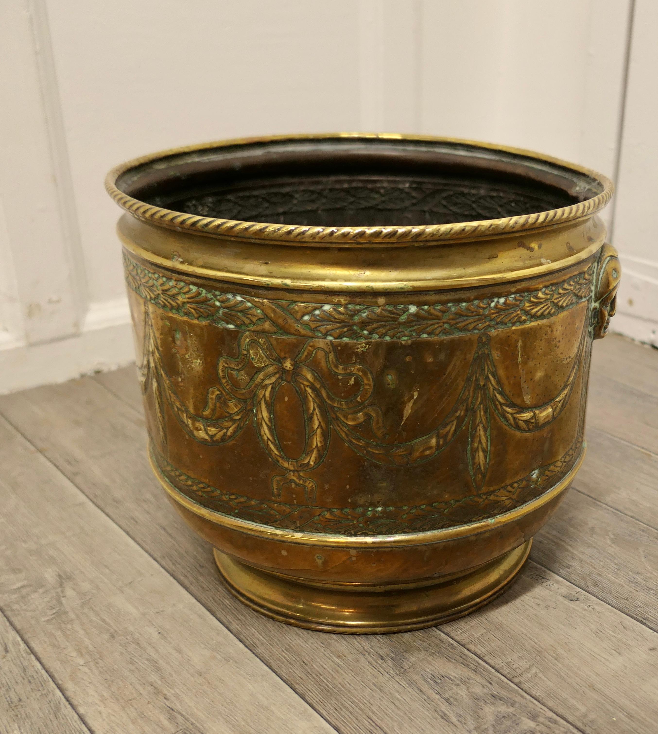 Large 19th century brass jardinière with faces

This is a good quality piece of solid brass craftsmanship, the Jardinière has a rolled rope top edge and very unusual masks, one on each side
There are decorative swags around the planter in the